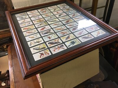 A box of cigarette cards plus two framed sets