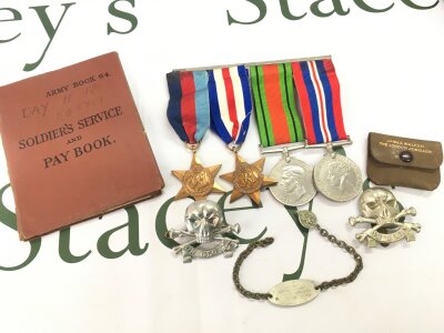 A group of WW2 medals 39-45 star, France and Germany star, Defence medal, war medal also including a soldiers service and pay book belonging to a Harry Reginald Day and a bracelet that reads Trp H.Day 558 701 Light Tank R.A.C , and the reverse Quaray Hill Boro Green Kent. Two Death or glory cap badges .
