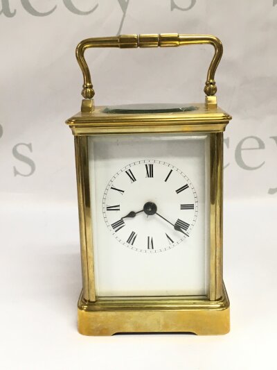 A brass carriage clock, approx height 17cm including handle.