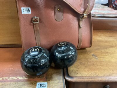 A leather case containing bowling balls .- NO RESERVE