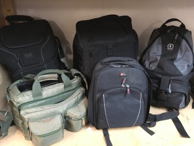 Camera bags and a collection of tripods, a bag including various fitted equipment including colour filters