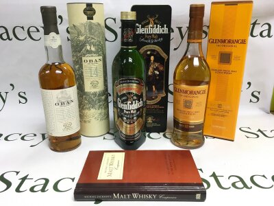 Three boxed single malt whiskeys comprising Glenfiddich, Glenmorangie and Oban examples plus a malt whisky book (4).