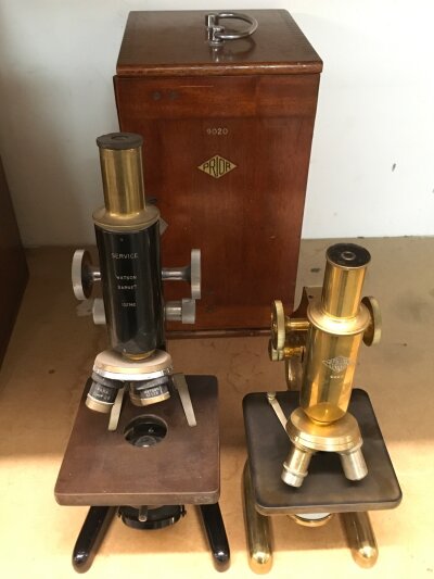 A prior microscope and one other both a fitted wooden Prior case
