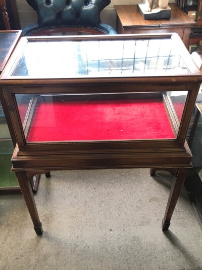 A mahogany shop display cabinet featuring glass panels and a red velvet lining. Dimensions 64cm wide 38cm long 88cm tall