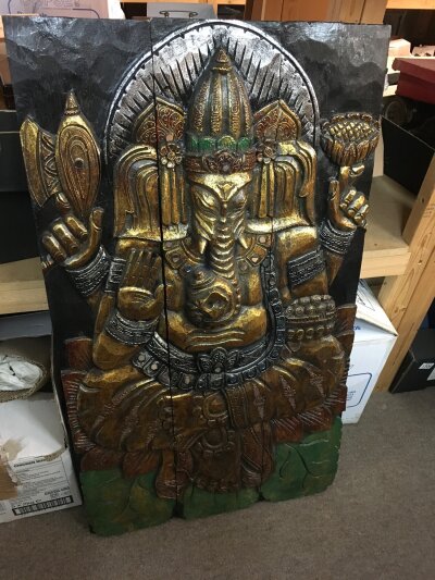 A 20th Century carved wooden three panel screen depicting Ganesha, approx 58cm x 100cm.