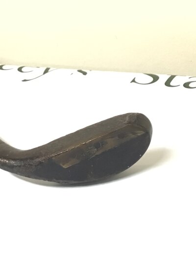 An Antique golf club possible as early as 1830 a grassed driver the head infield with led with brass edge with small rivet's  stamped with the maker R Foragan. Length 99cm