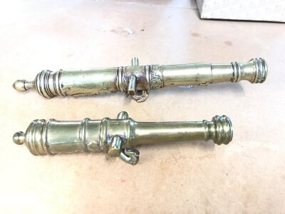 Two antique miniature brass desk cannons.
Larger one is 27cm long.