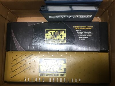 An assortment of Star Wars CCG cards , boxes and binders