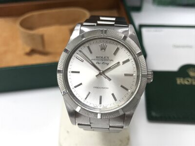 Rolex Air-King Precision, specifically reference 14000M, featuring a 34mm stainless steel case and a distinctive engine-turned bezel. Box and papers.