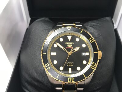Seiko 5 Sports Automatic SRPB94K1, featuring a distinct two-tone stainless steel and gold-plated bracelet. Seen running.