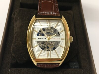 Thomas Earnshaw Catton Automatic watch featuring a gold-toned tonneau case and a skeletonized dial. Seen running.
