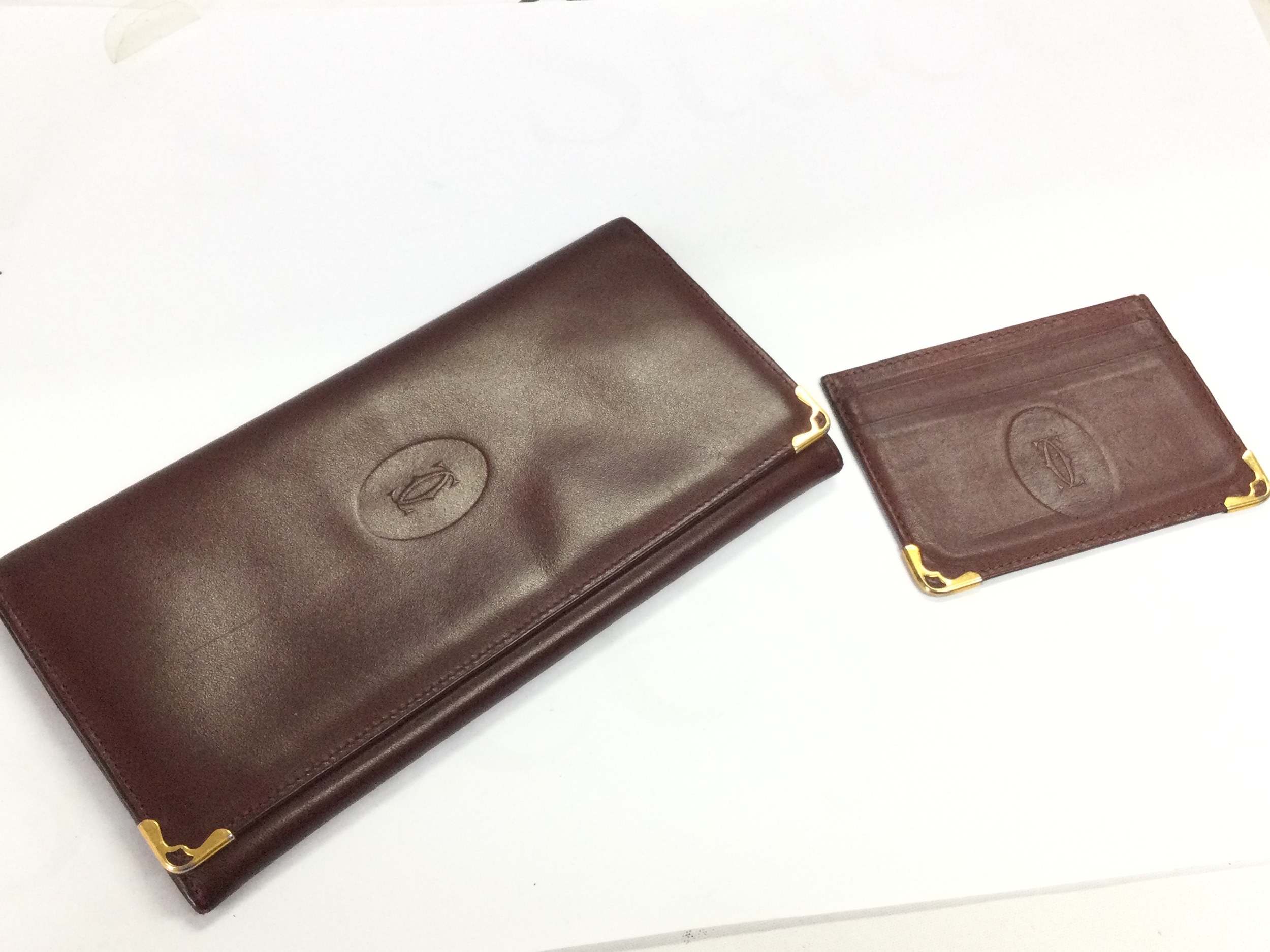 A Cartier Paris leather wallet and card case. 90Cm long