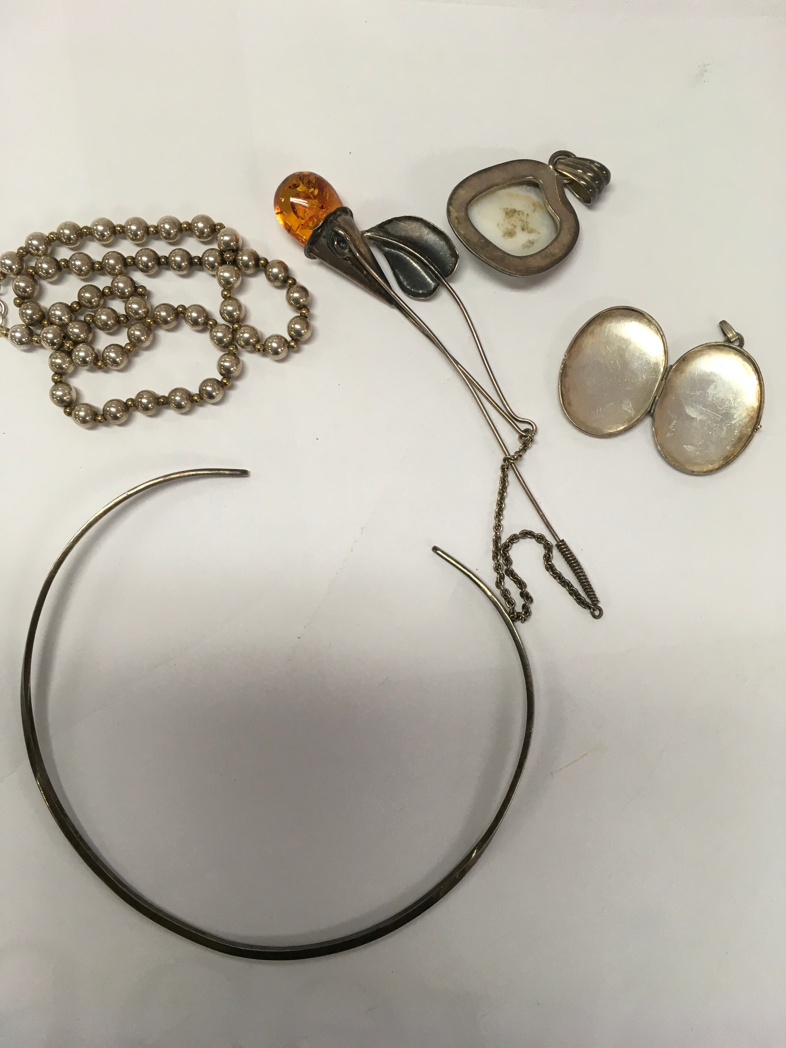 Silver modern  jewellery includes amber.