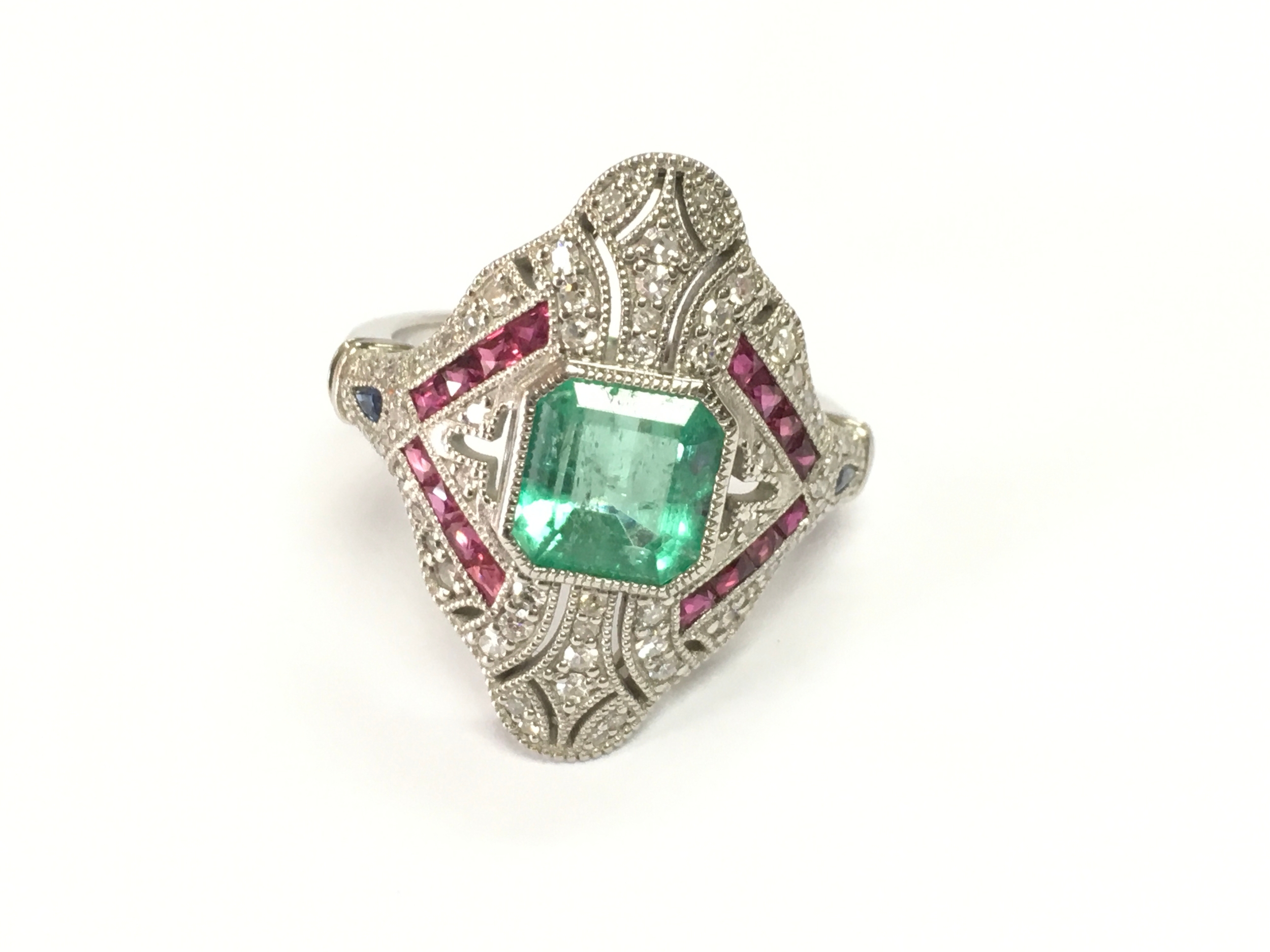 Platinum art deco style emerald, ruby sapphire and diamond fancy dress ring. Size O