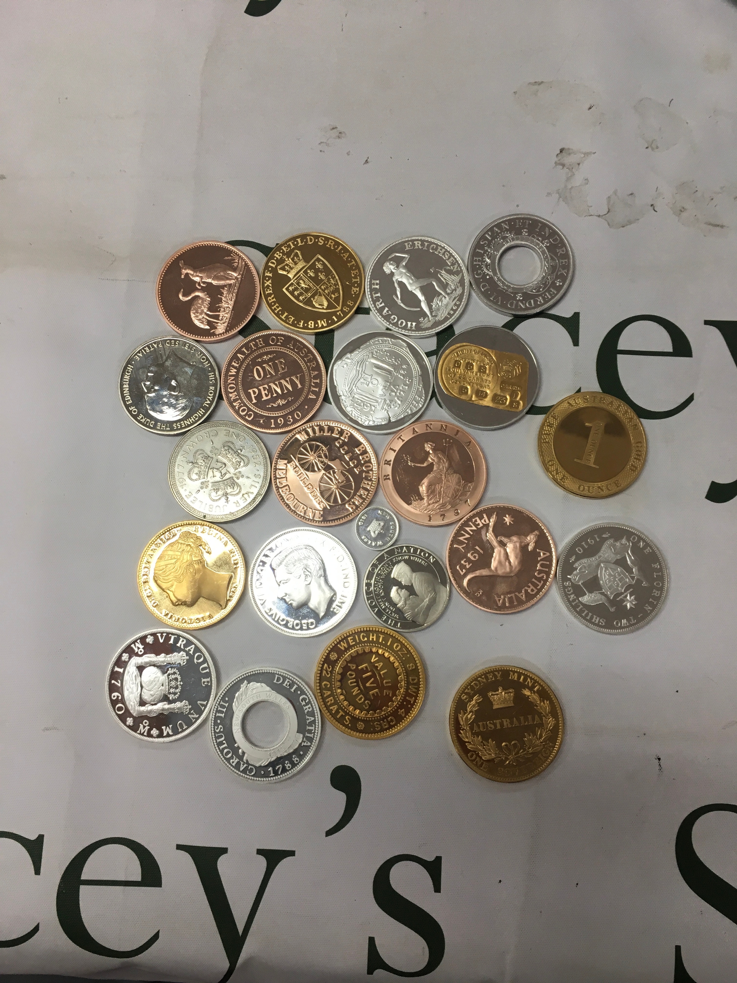 A collection of replica coins and commemorative tokens. Many pieces appear to be historical replicas related to famous Australian numismatic history 