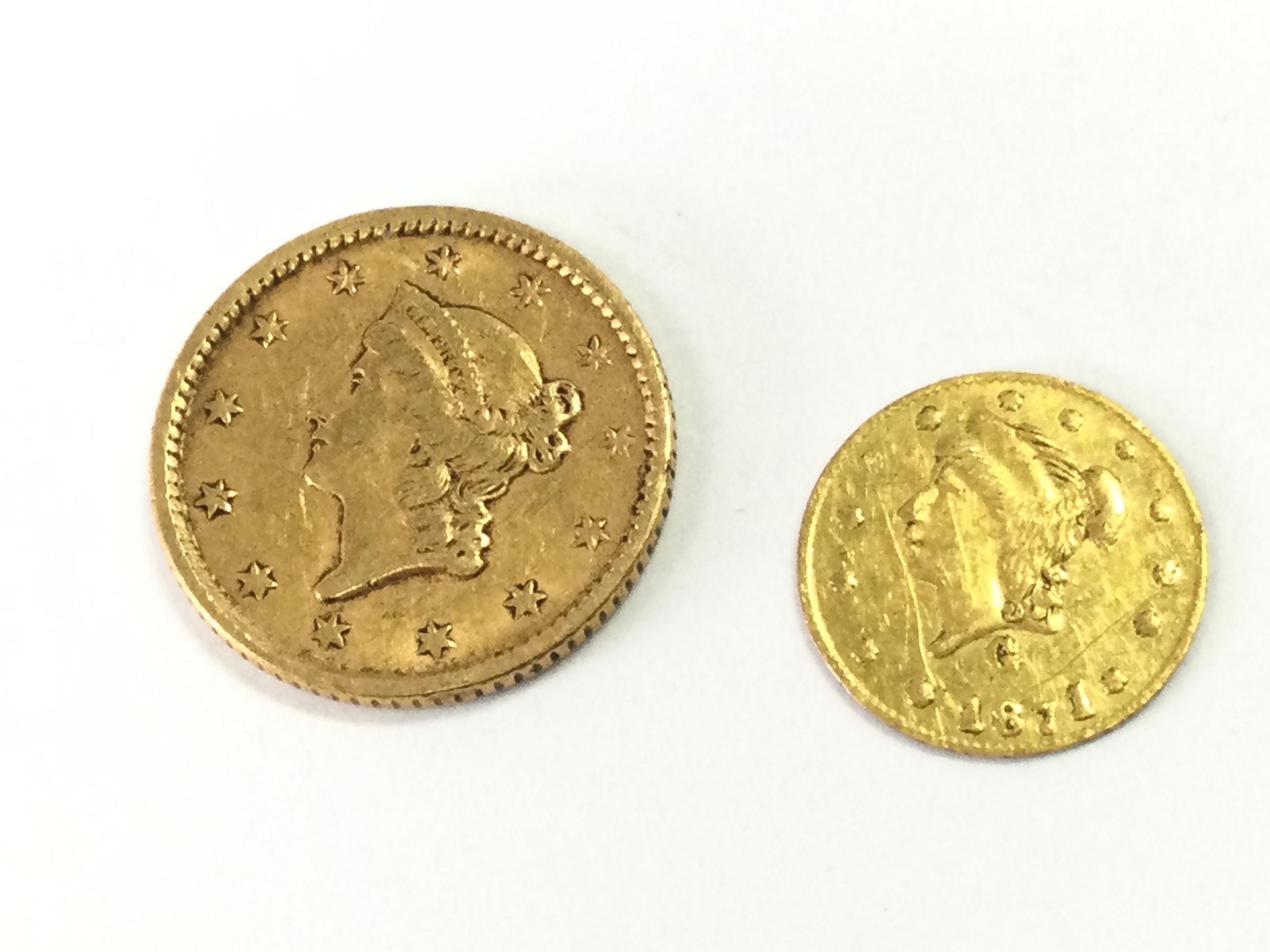 Two small gold American coins . One dollar and 1/2 dollar. 1.9g total weight 