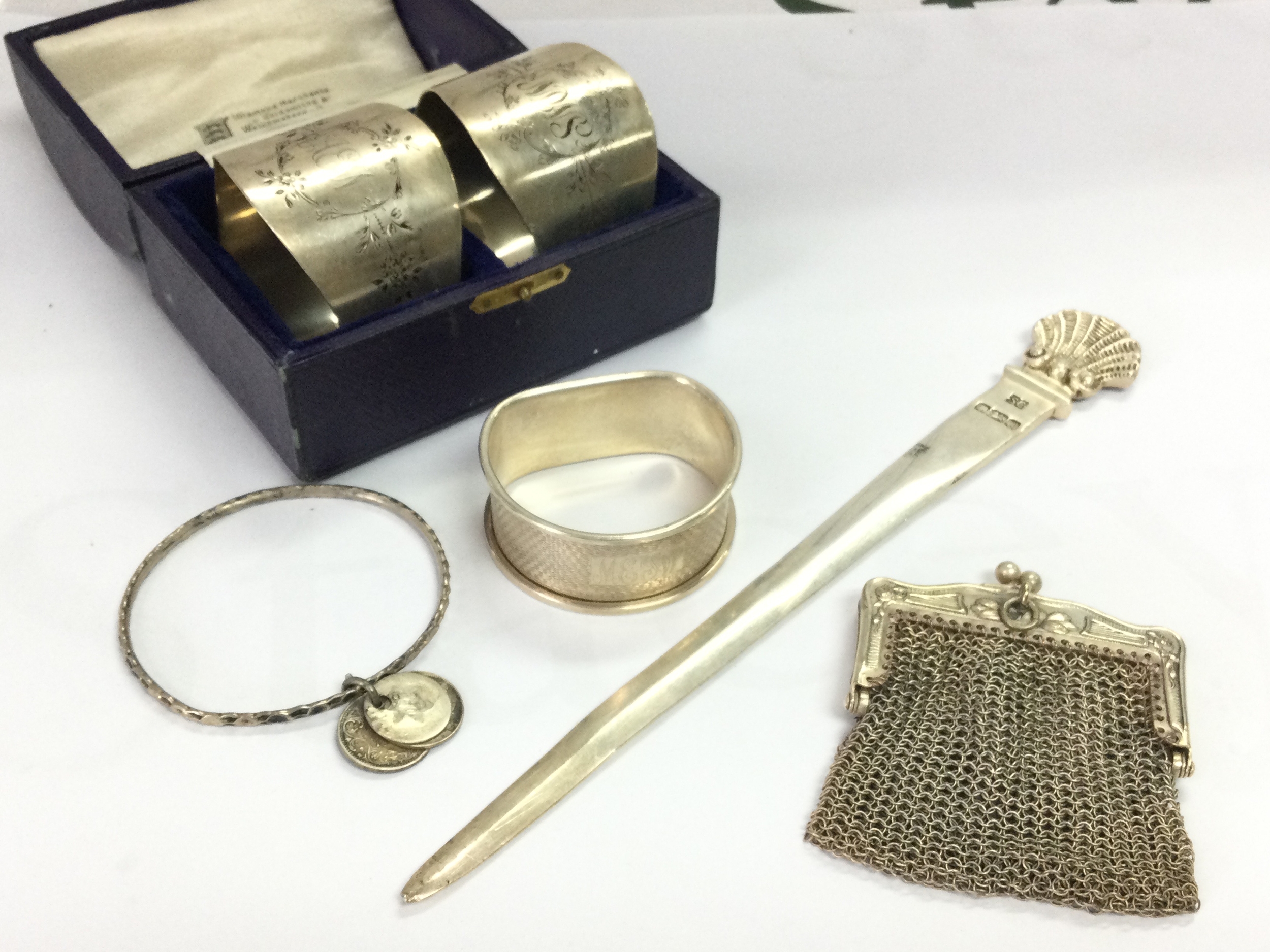 Silver items including a paper knife, napkin rings, chain mail purse etc. 170g total weight 