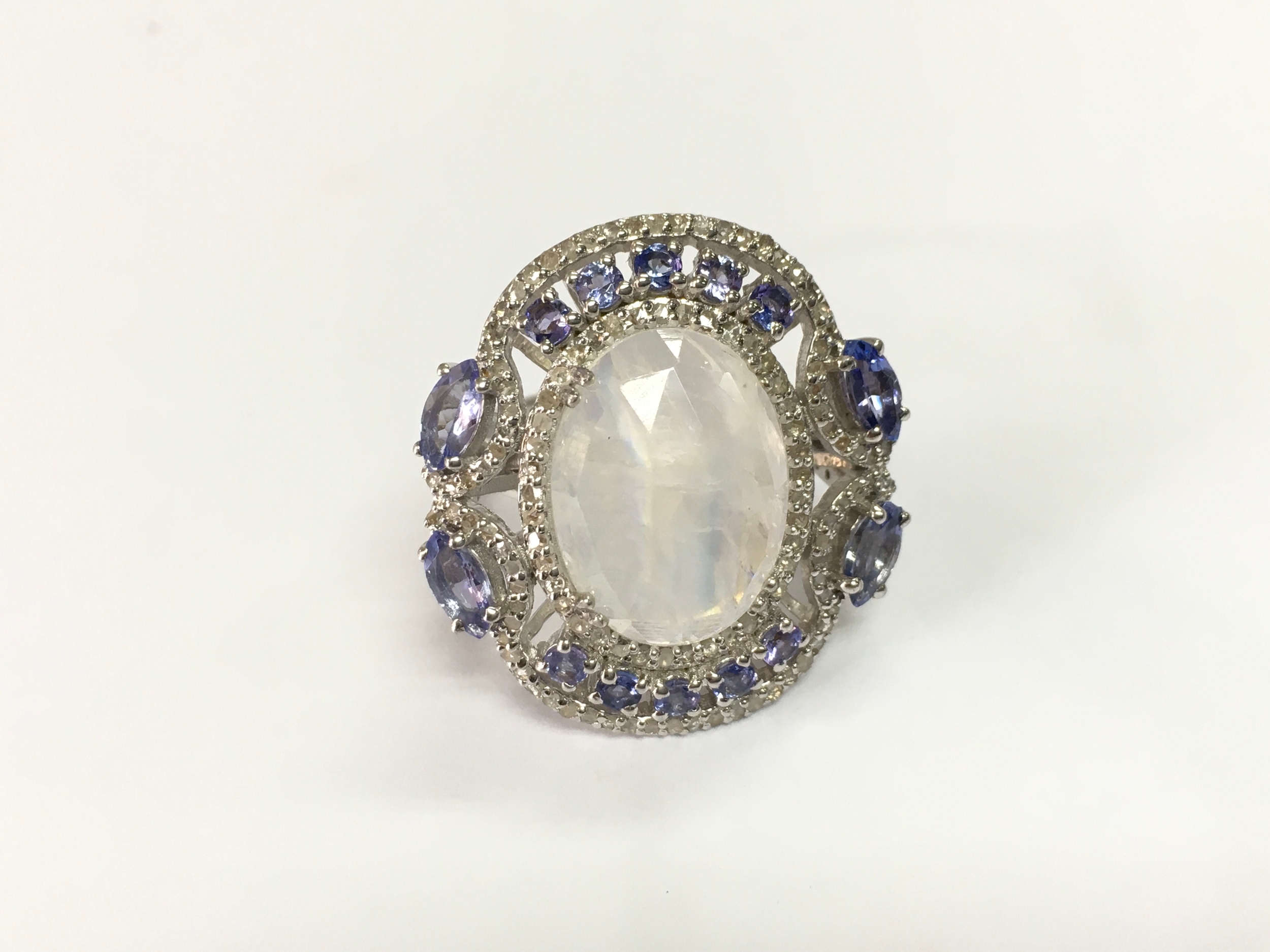 Silver dress ring set with rainbow moonstone pear and round tanzanite and diamonds. Size N 1/2