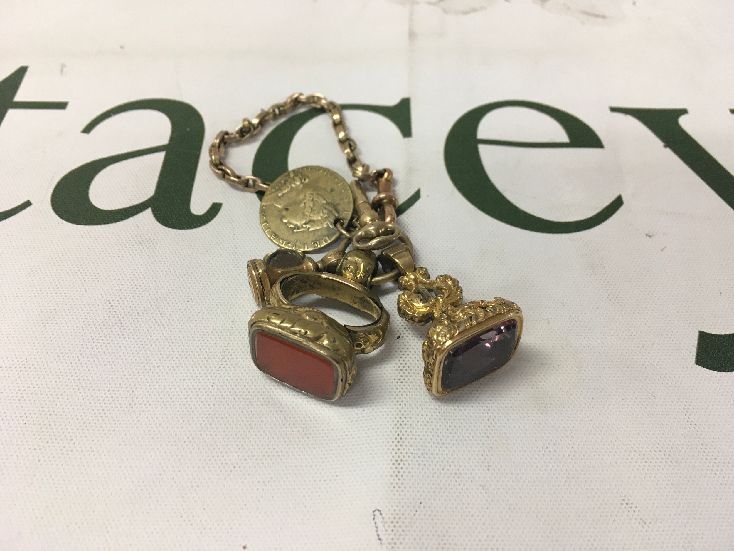 9ct chain and 3 seals to link carnelian stone, amethyst stone, pocket watch keys and multiple antique watch fobs. 