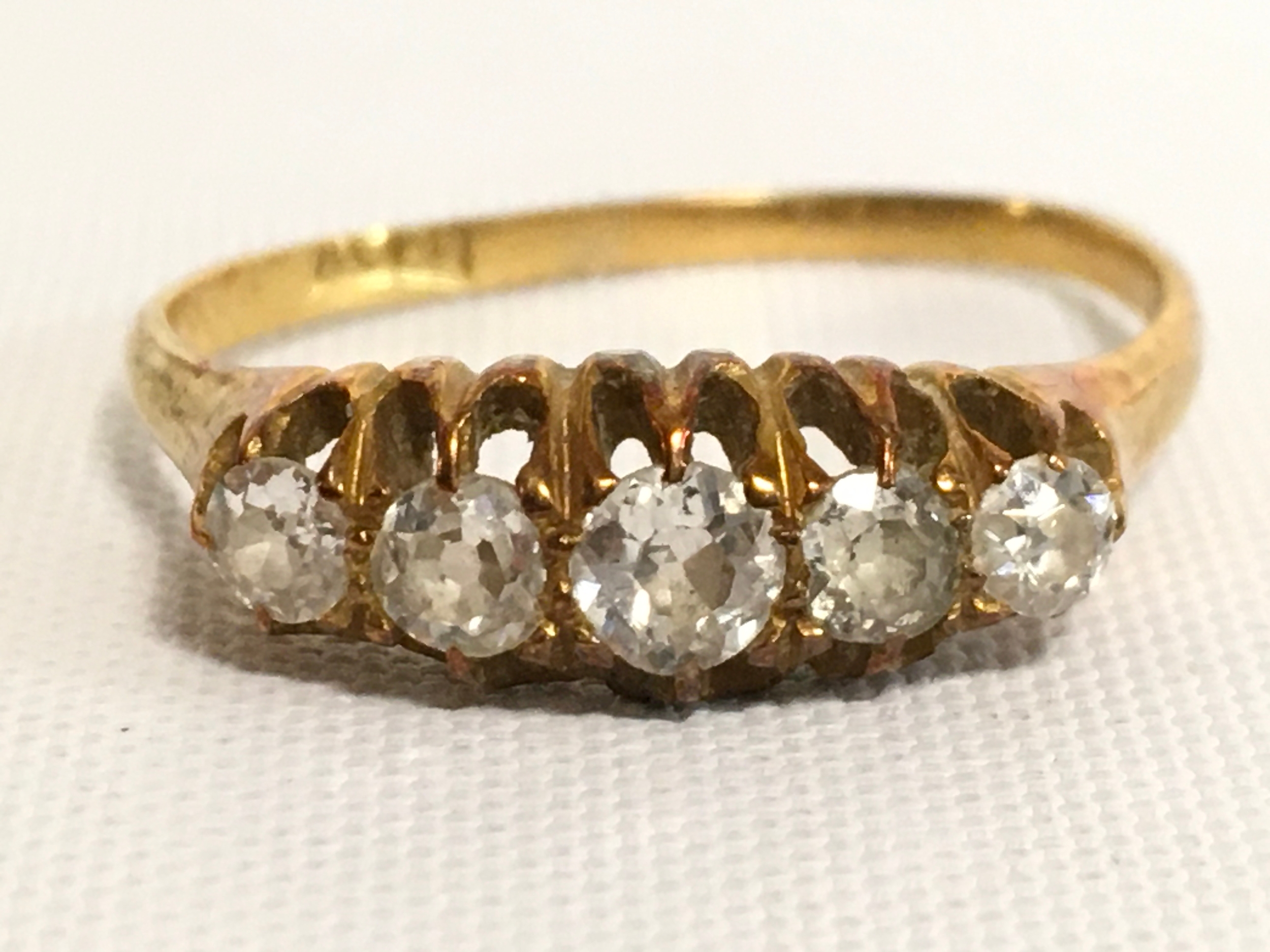 A five diamond 18ct gold ring . 2.9g total weight 