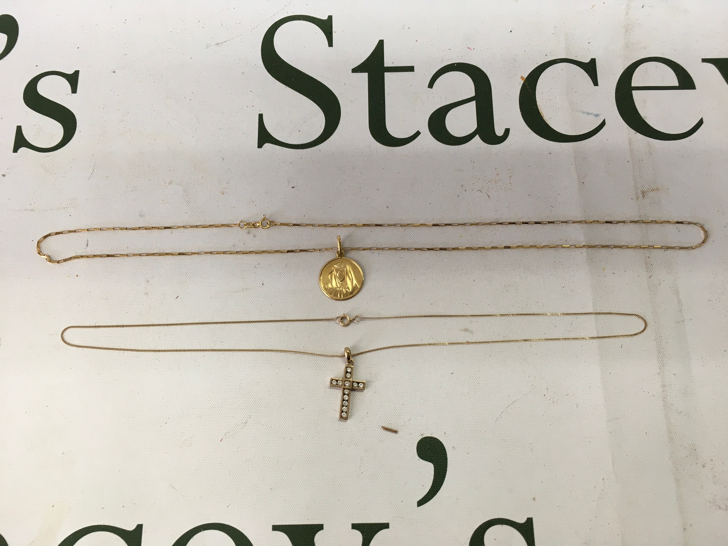 18 and 22 inch 9ct necklaces with 9ct crucifix and 14 ct religious pendant. 14 k pendant 2 gram 9 ct  4.5gram