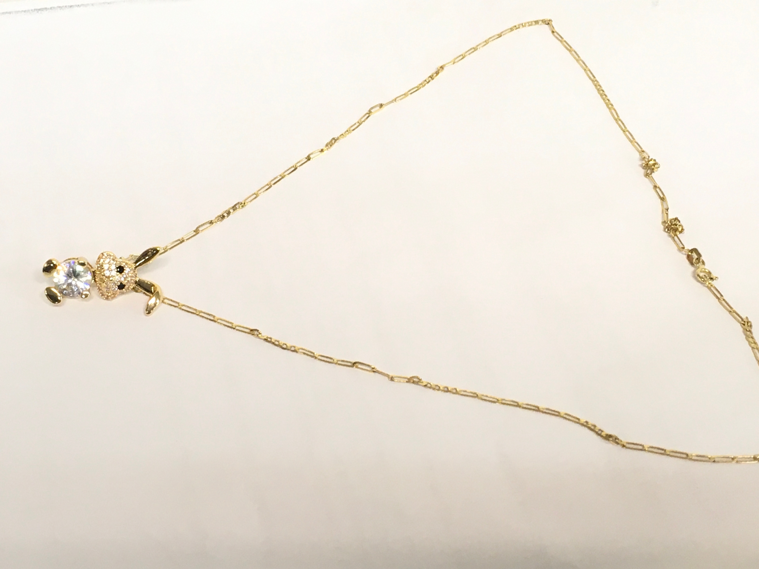A 9ct gold chain (20cm long) with a rabbit pendant attached 