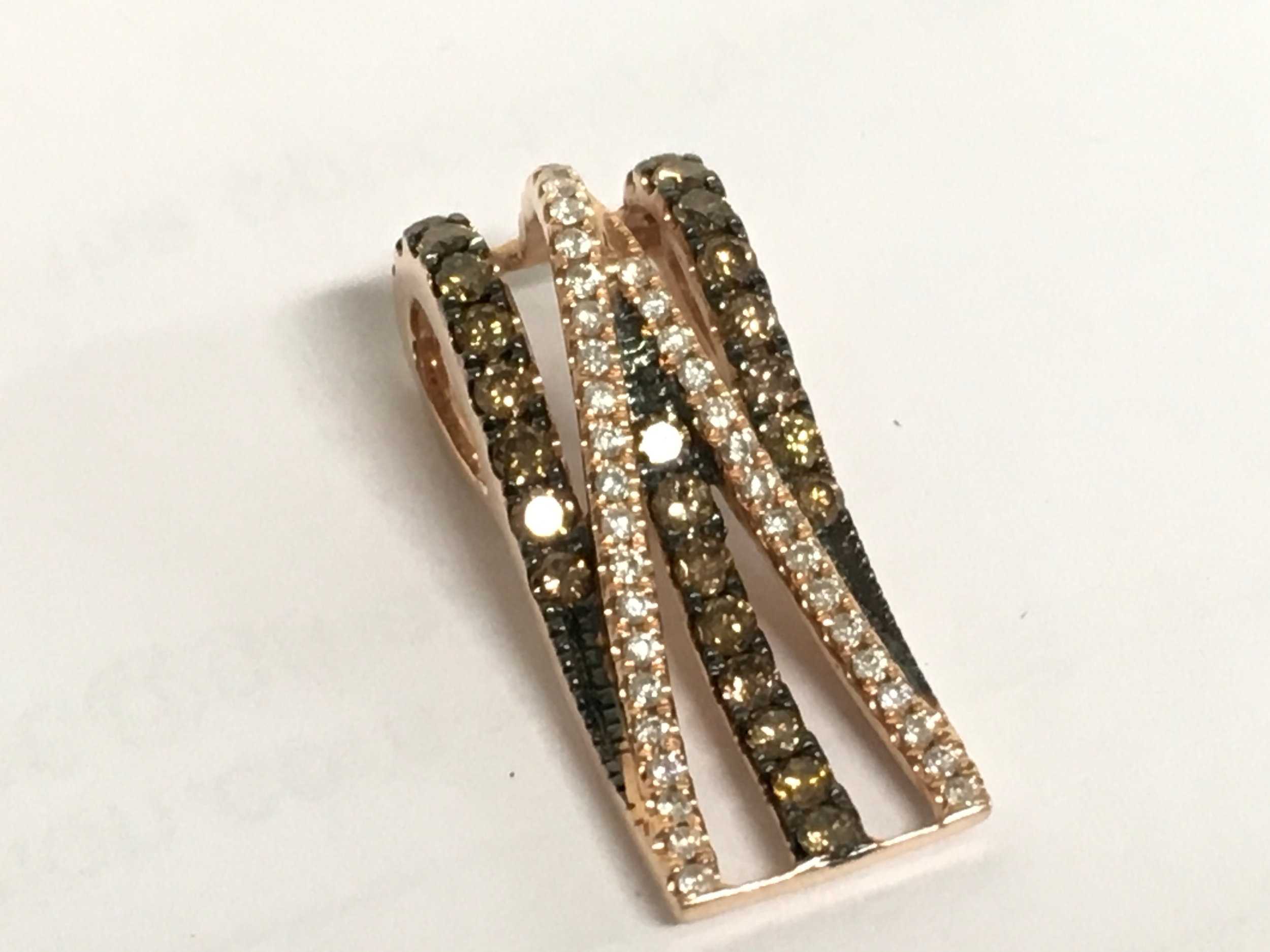 A 14ct gold pendant set with various stones. Approximately 2.4cm long