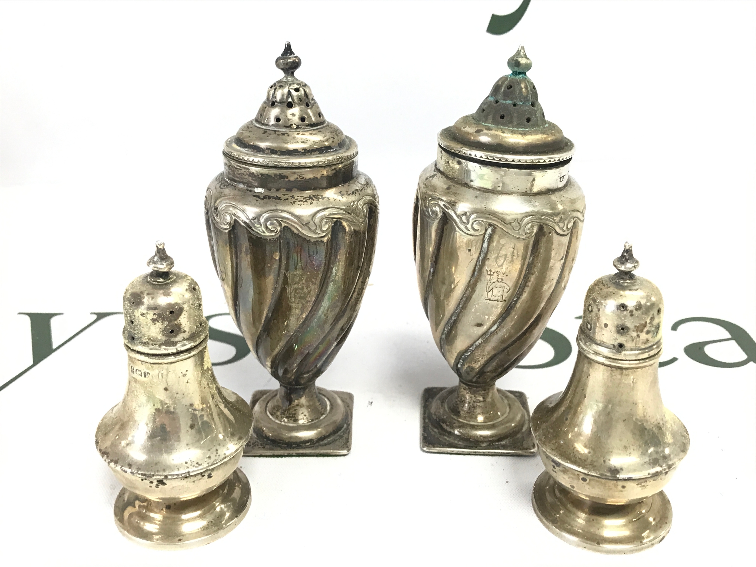 Two pairs of hallmarked silver cruets . 305g total weight 8 and 12cm tall