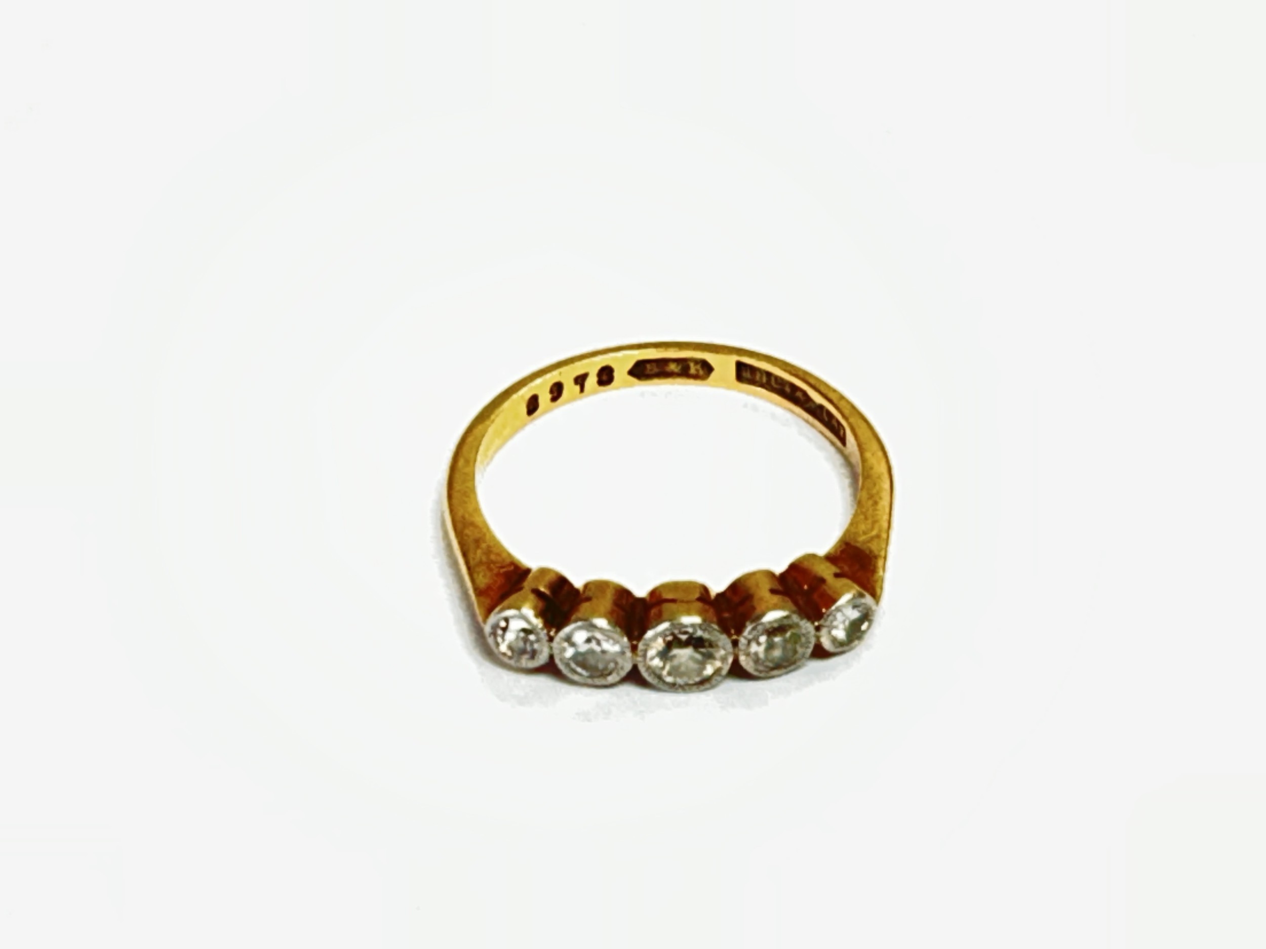 An 18ct gold and platinum ring set with a row of five old cut diamonds, approx 2.8g and approx size L-M.