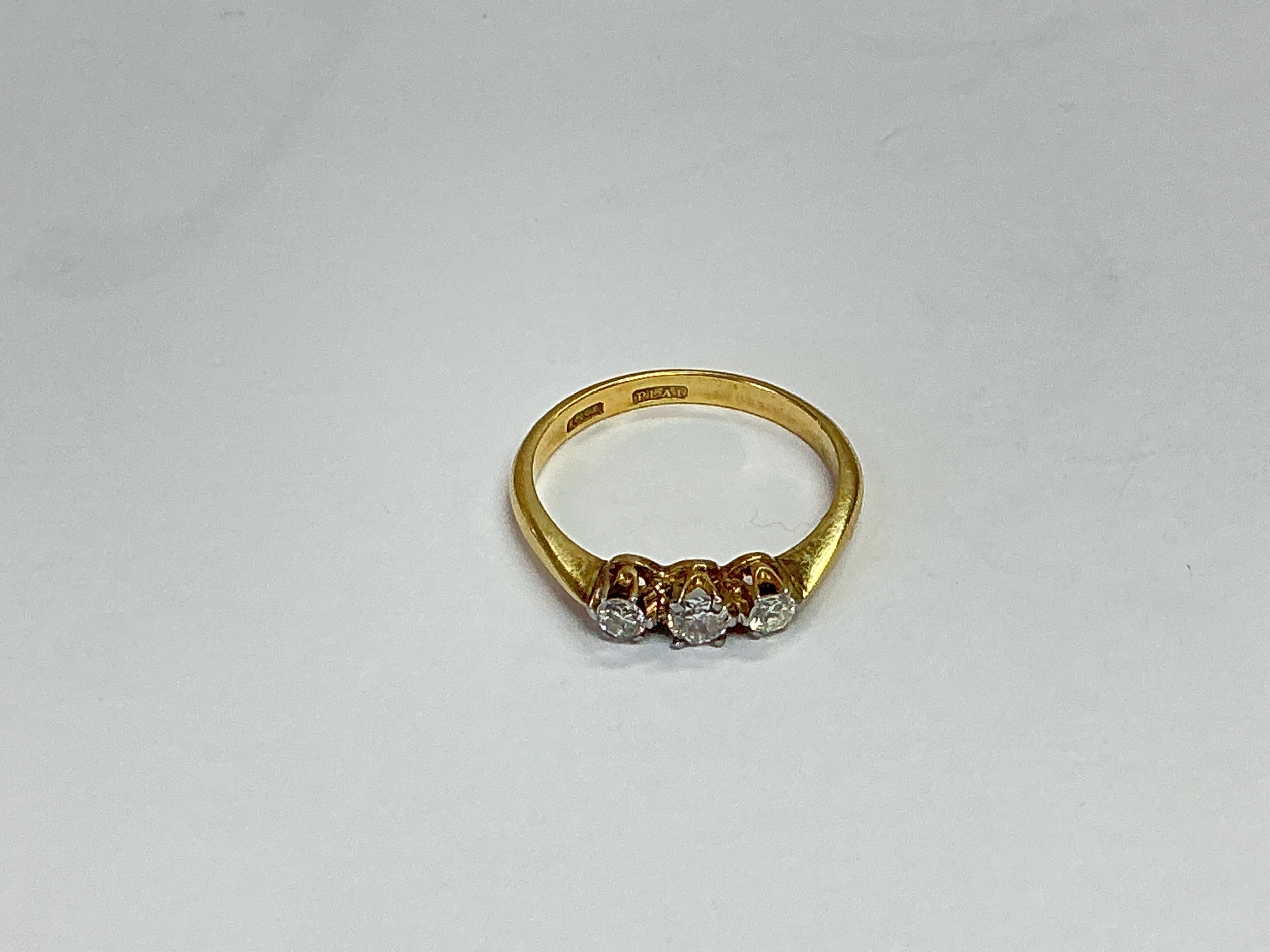 An 18ct gold and platinum ring set with three diamonds, approx 2.9g and approx size P.