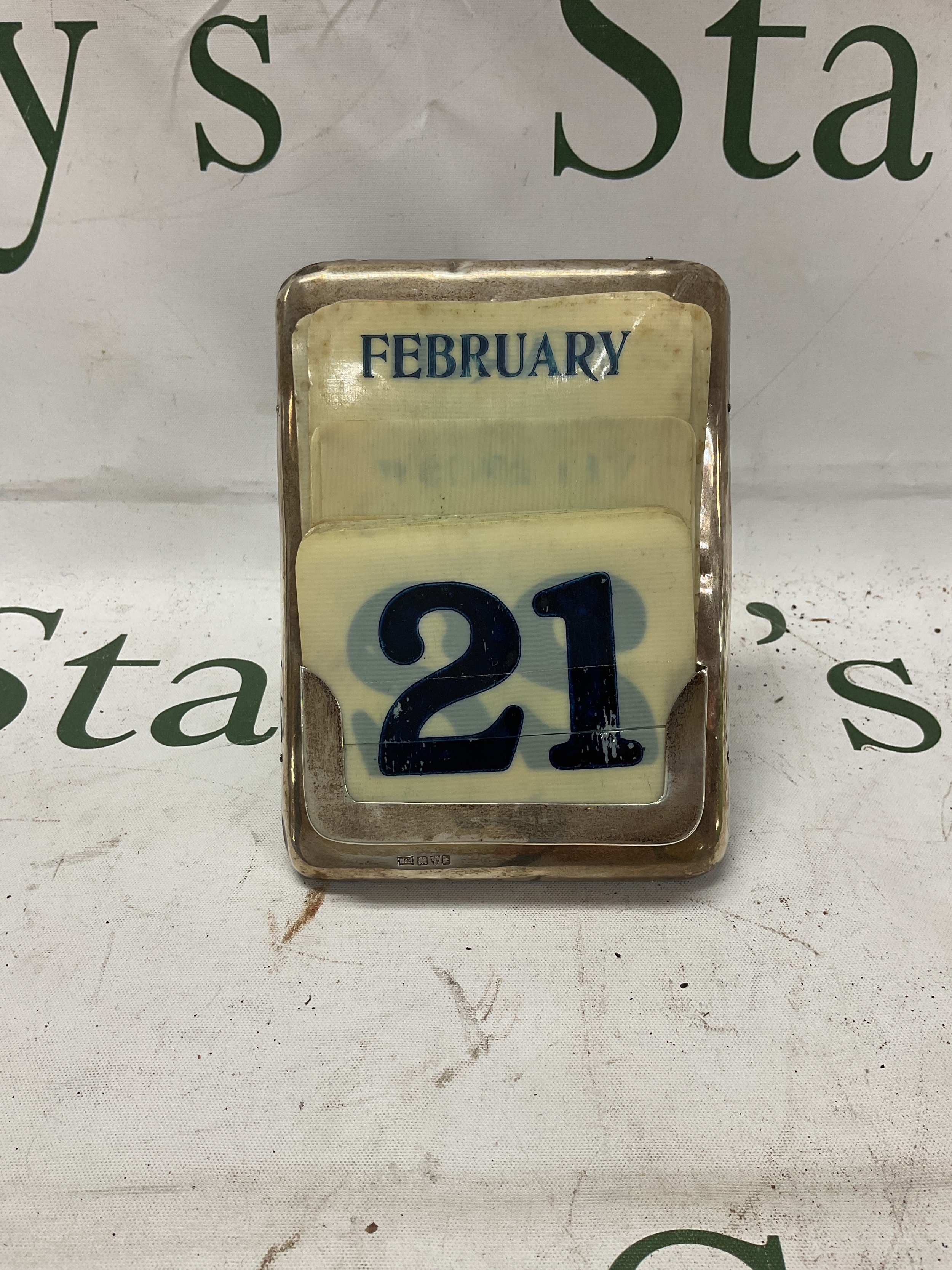 HM silver desk calendar with day, date and month, by Walker and Hall, Chester,1922.  On oak back with stand, All dates and months present missing days on celluloid cards.