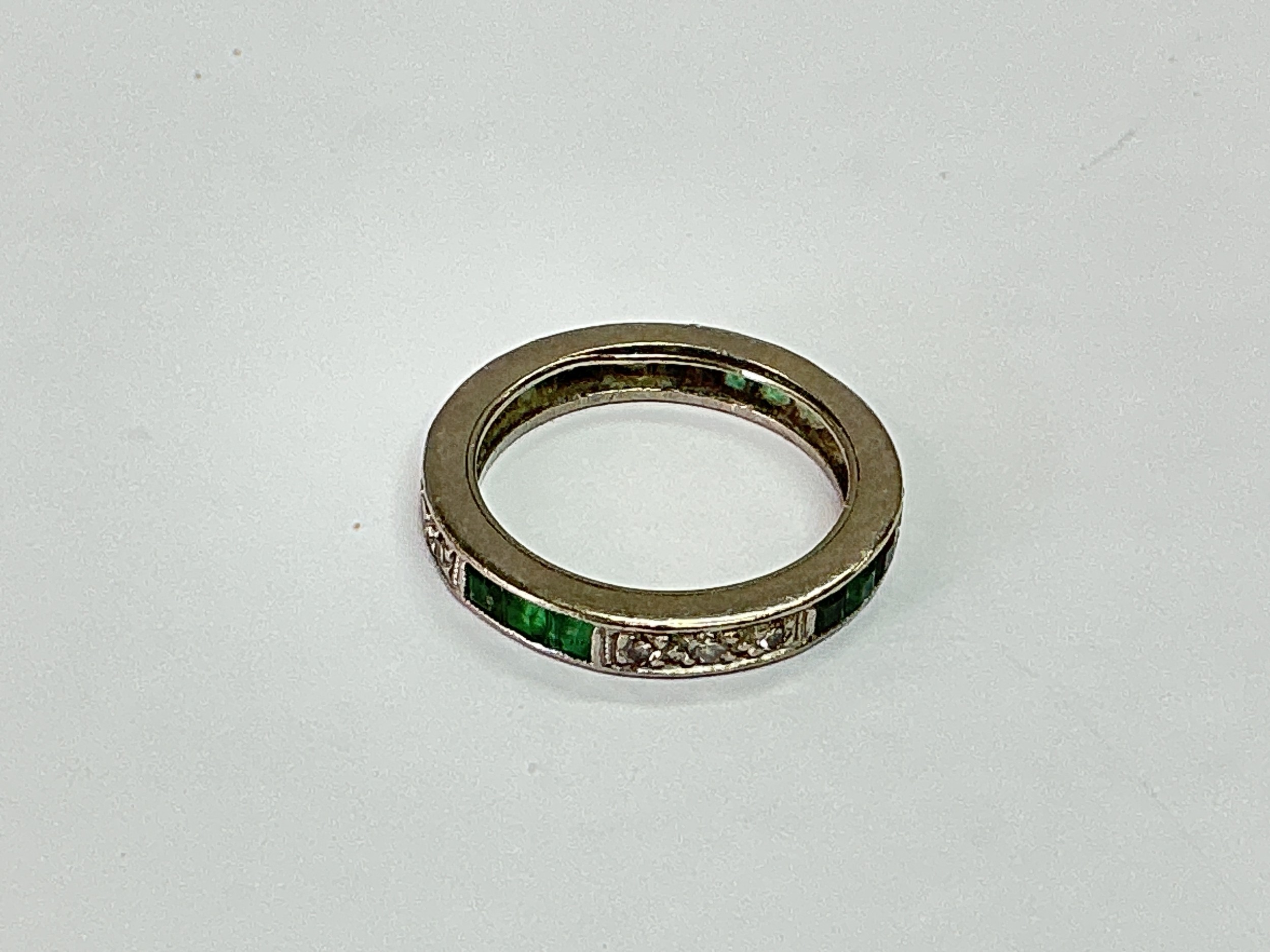 An emerald and diamond eternity ring, approx 3.8g and approx size J.