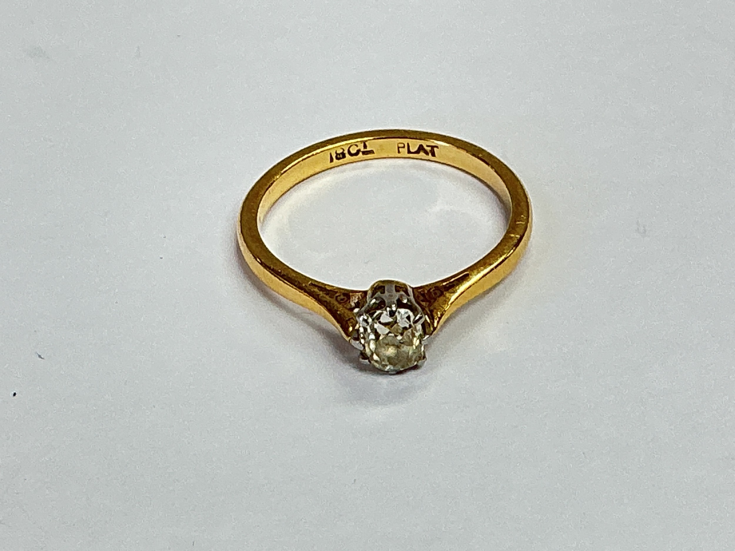 An 18ct gold and platinum diamond solitaire ring, approx 2g and approx size J.