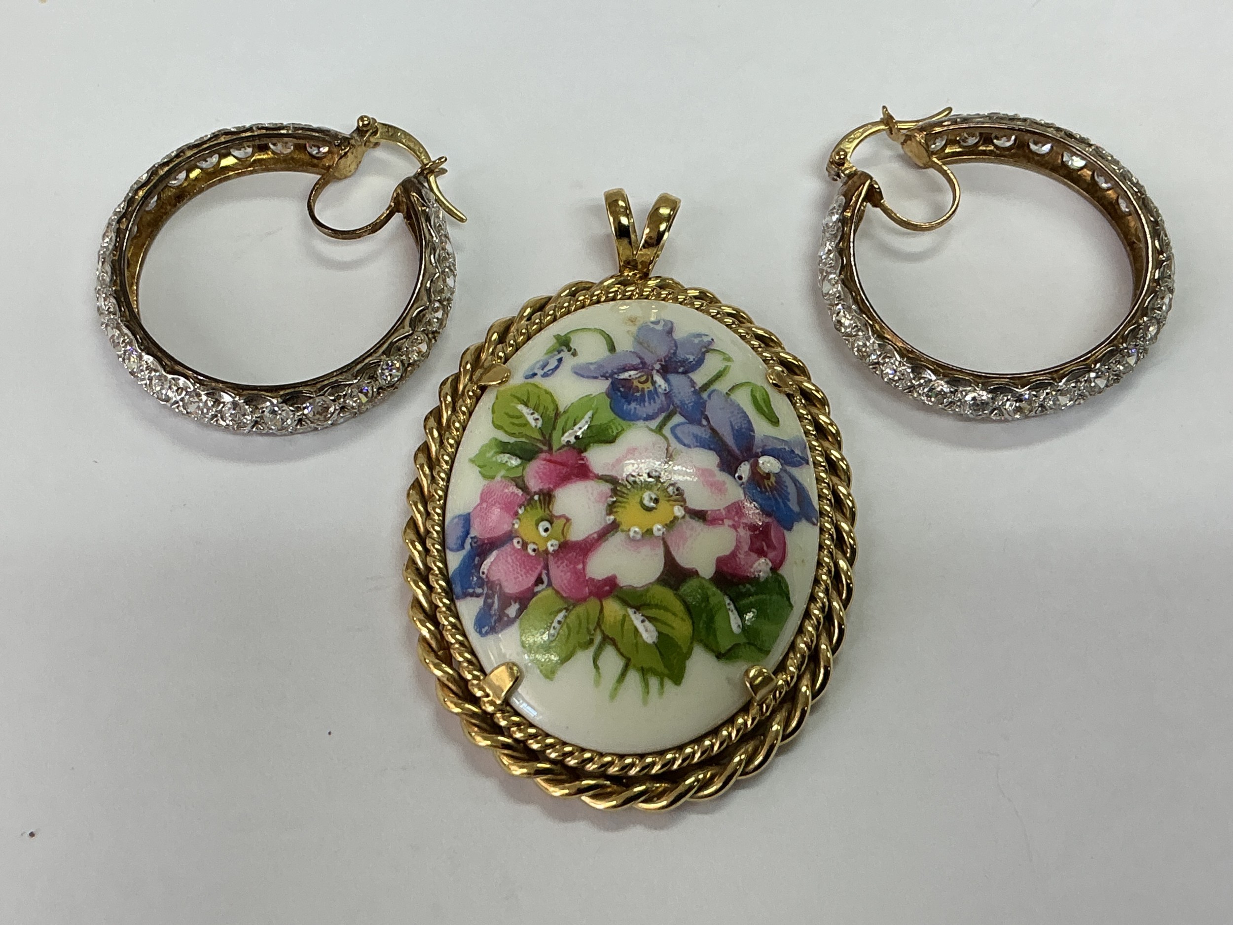 A 9ct gold and hand painted Limoges brooch together with a pair of 9ct gold earrings set with CZs.