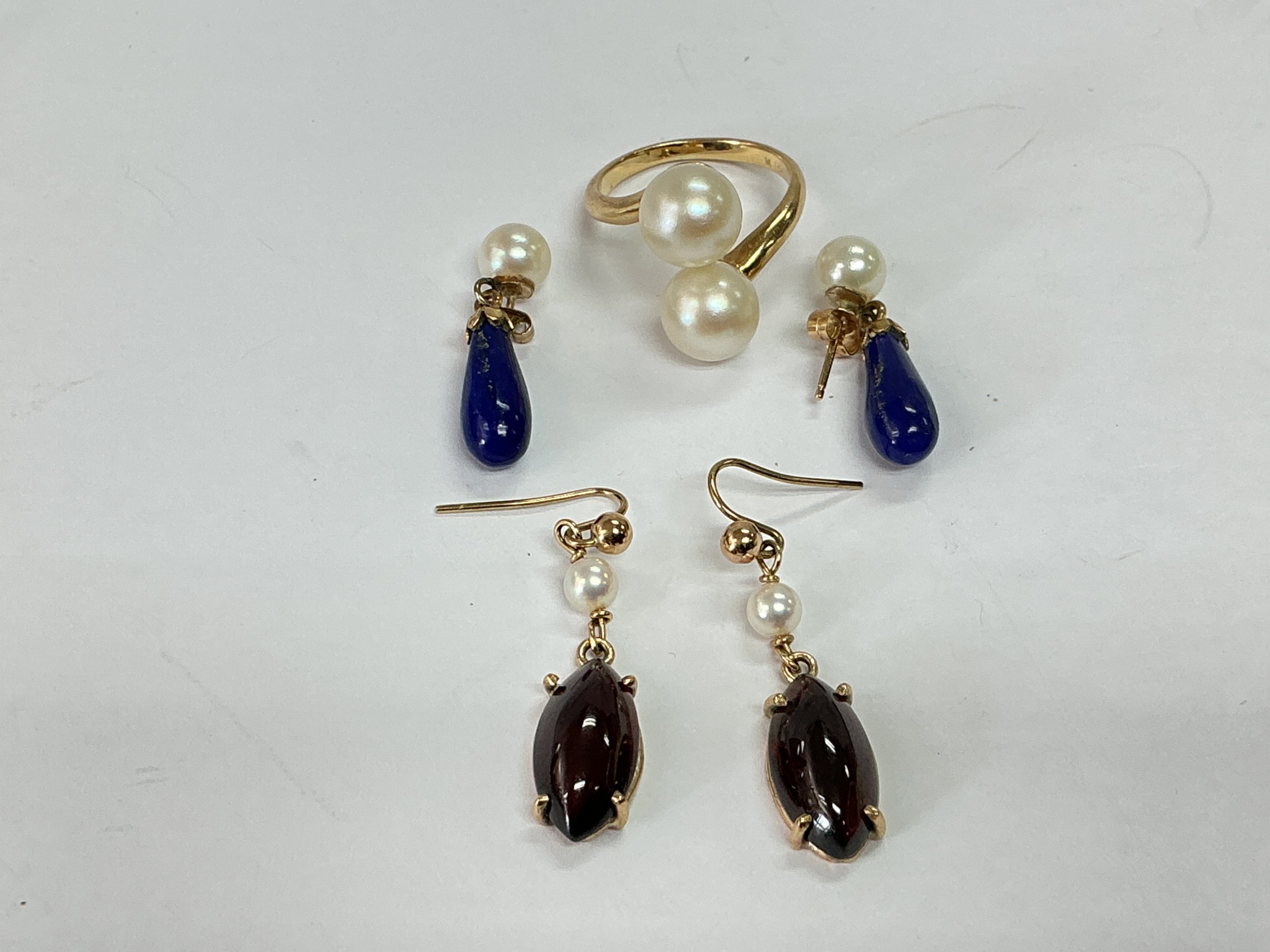 A 14k gold ring set with two pearls together with two pairs of earrings set with pearls and other stones. Total approx 7.9g.