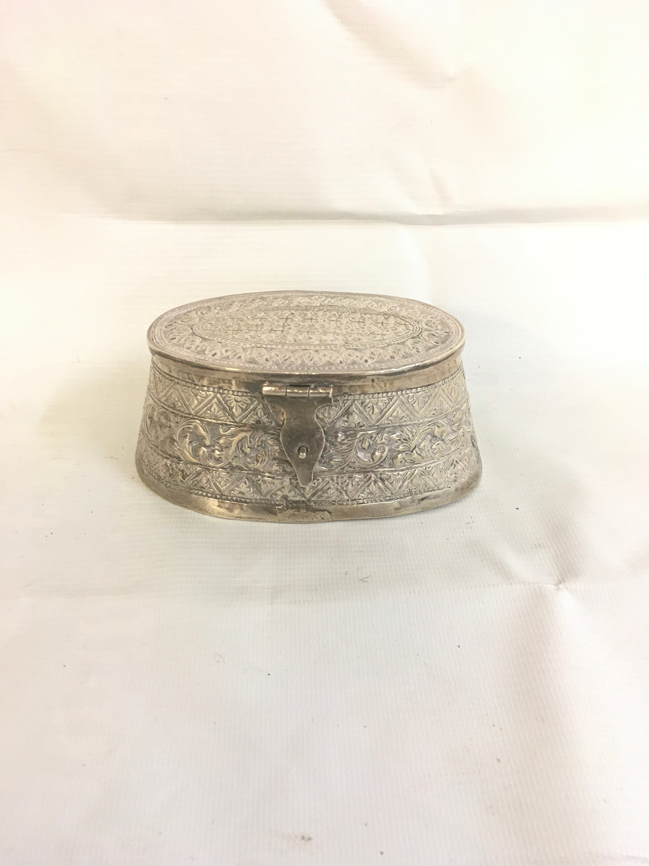 oval embossed indo-persian white-metal jewellery/trinket box. 