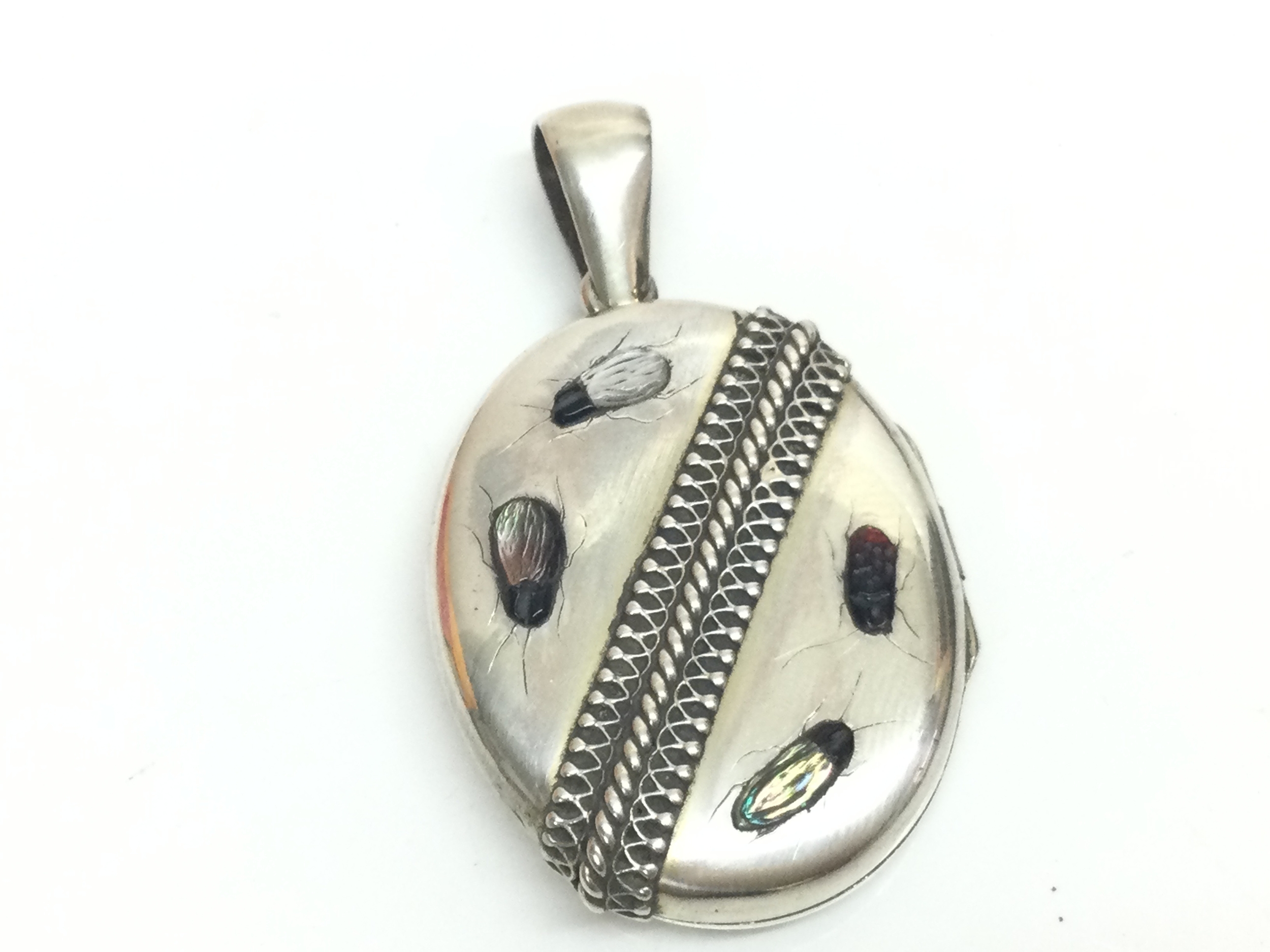 An antique silver Shibayama locket. 3.5Cm tall