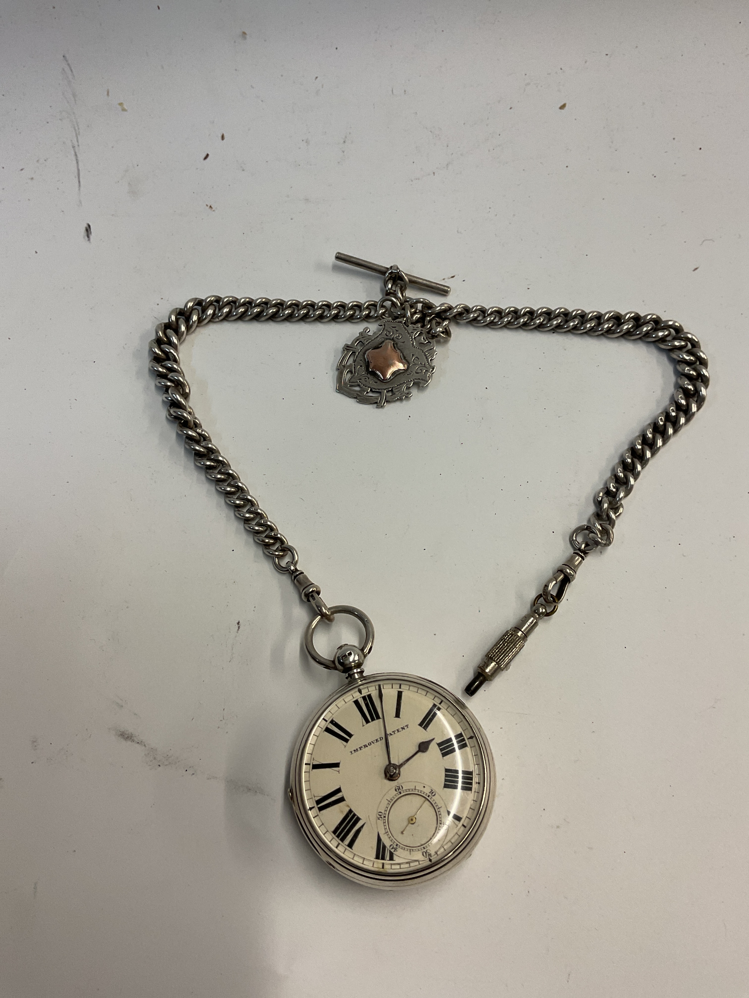 19th c Silver pocket watch, Albert chain, fob and T-bar, improved paten to the dial with key for winding, large case 52mm, 