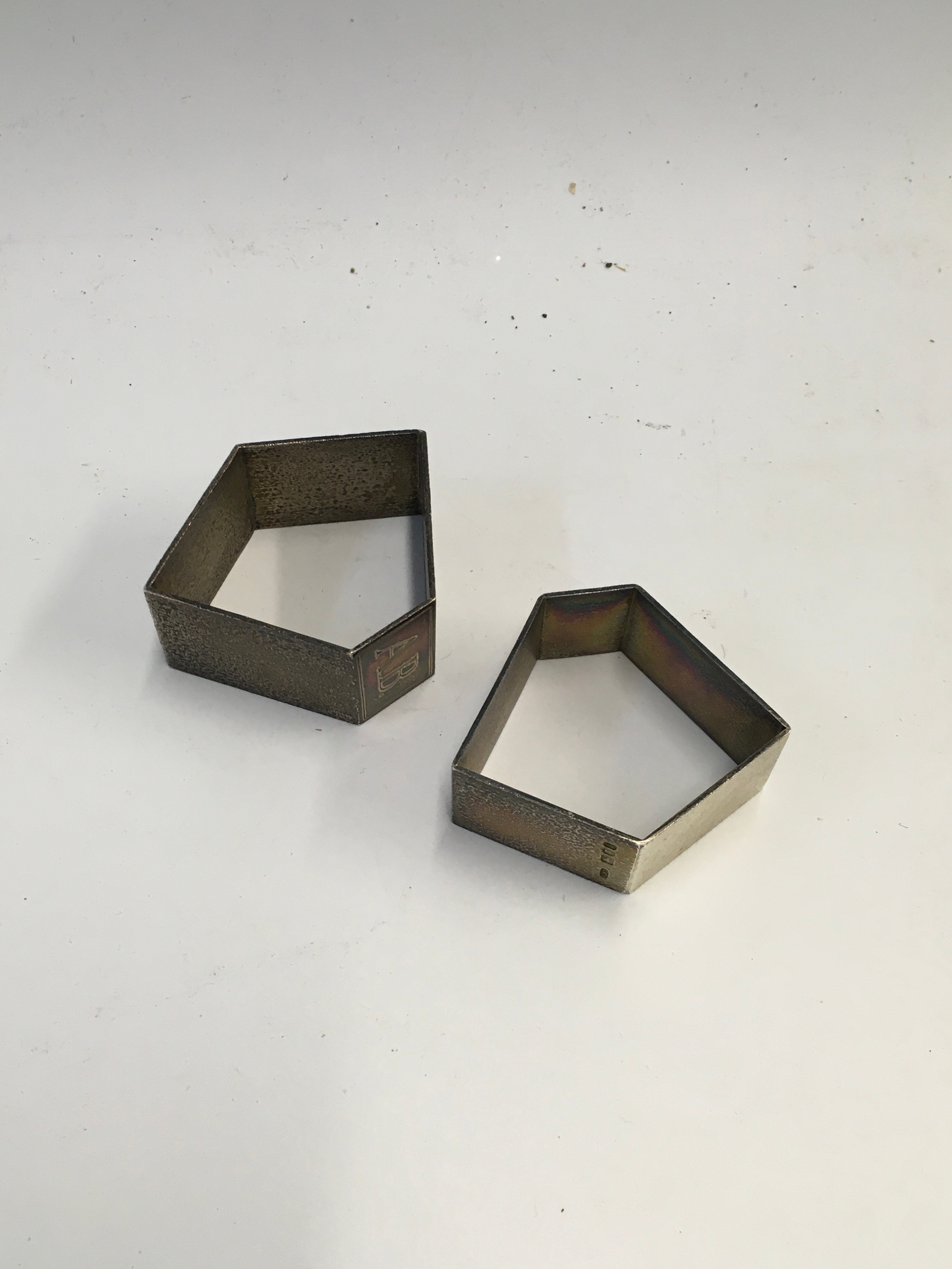 A pair of Christopher Nigel Lawrence napkin holders hallmarked London 1975