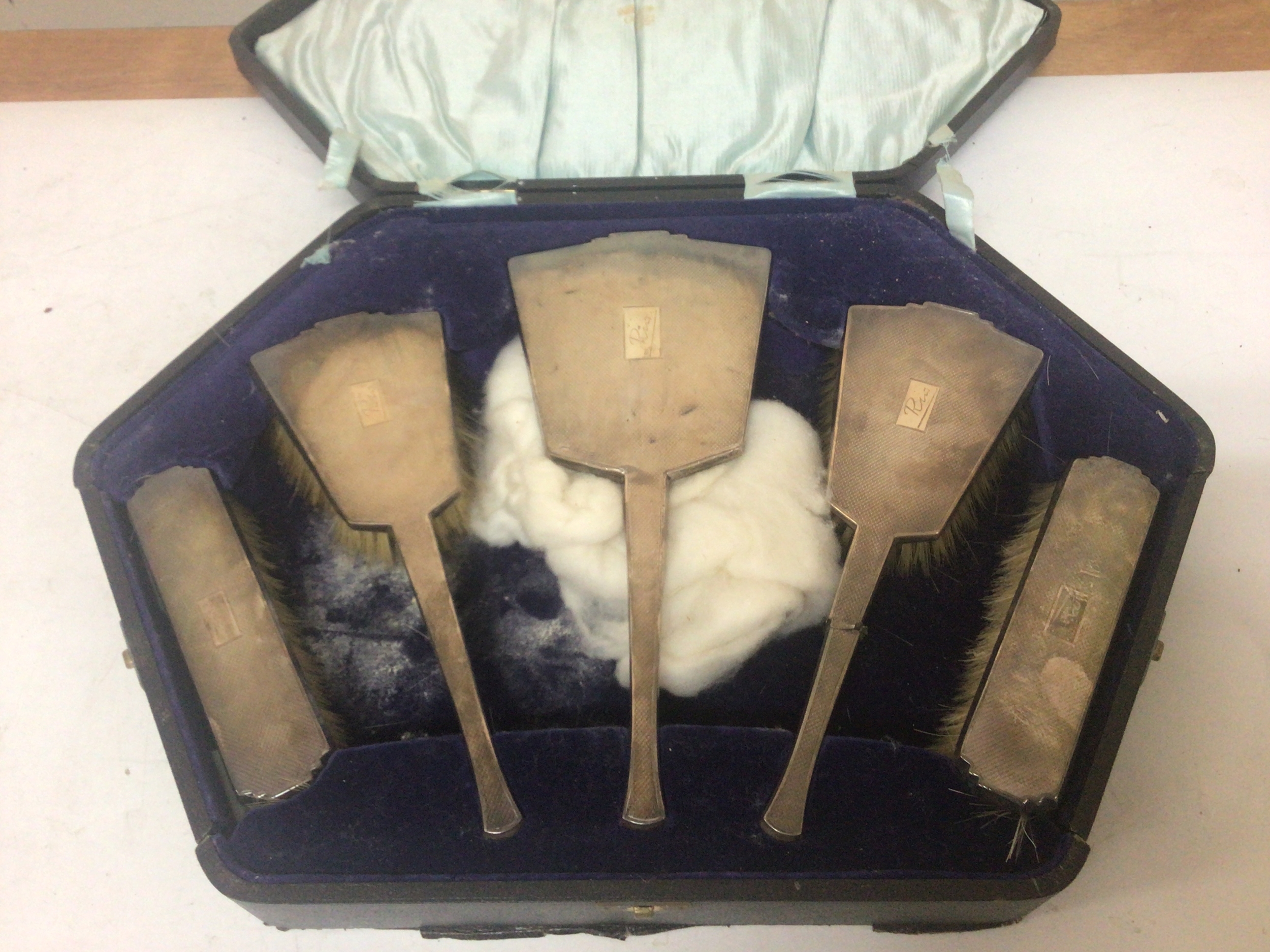  A cased silver dressing table set Birmingham hallmarks one brush damaged. 