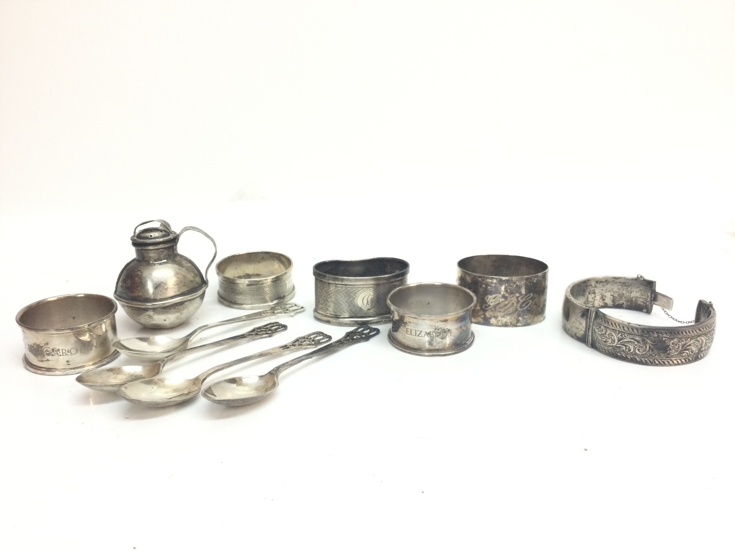 A collection of silver hallmarked items including spoons, napkin rings, bangle. 185g total weight