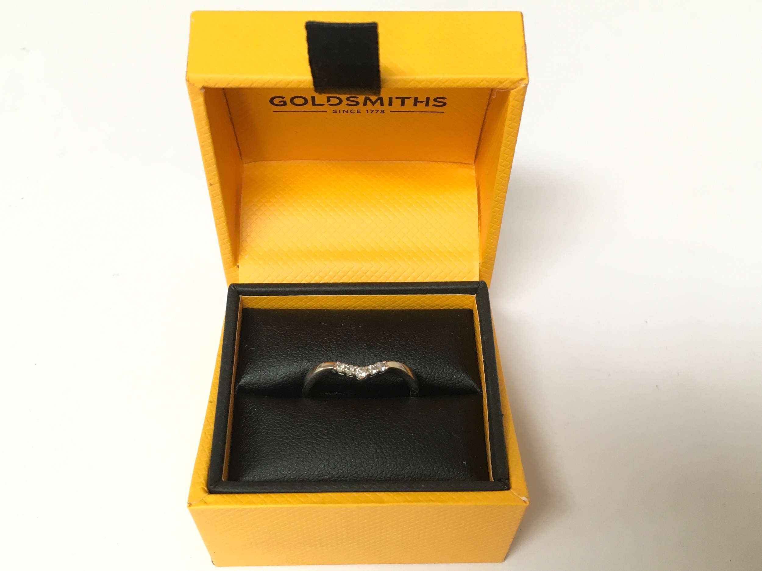18 carat white Gold with inset diamond band. Size L, weight, 2g includes Goldsmiths box.