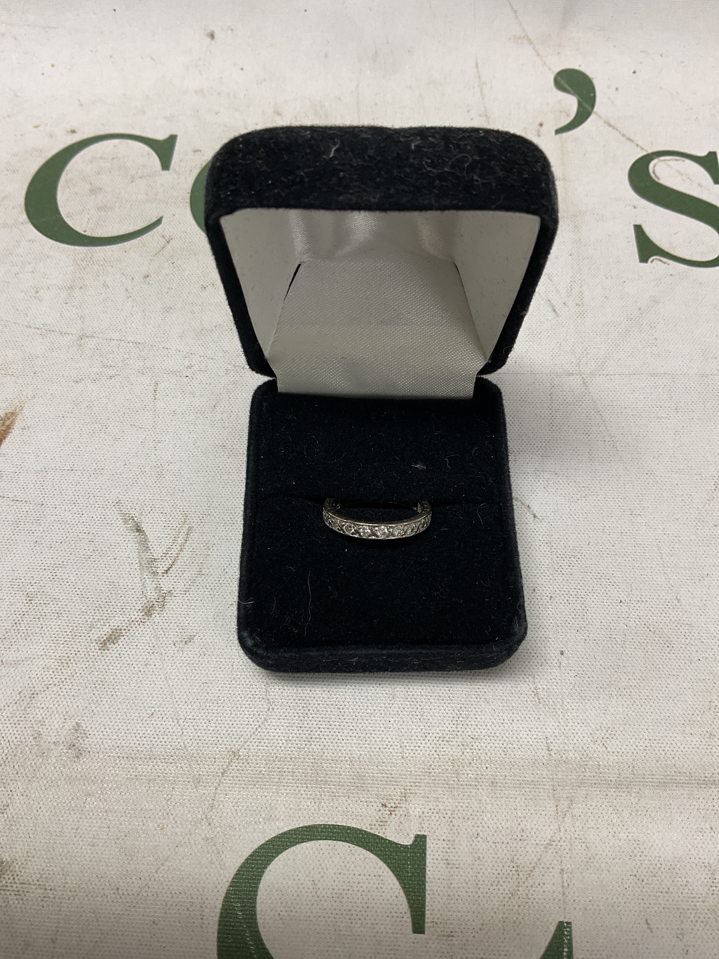 Unhallmarked diamond full eternity ring approx size K. Weight 2.8 grams.