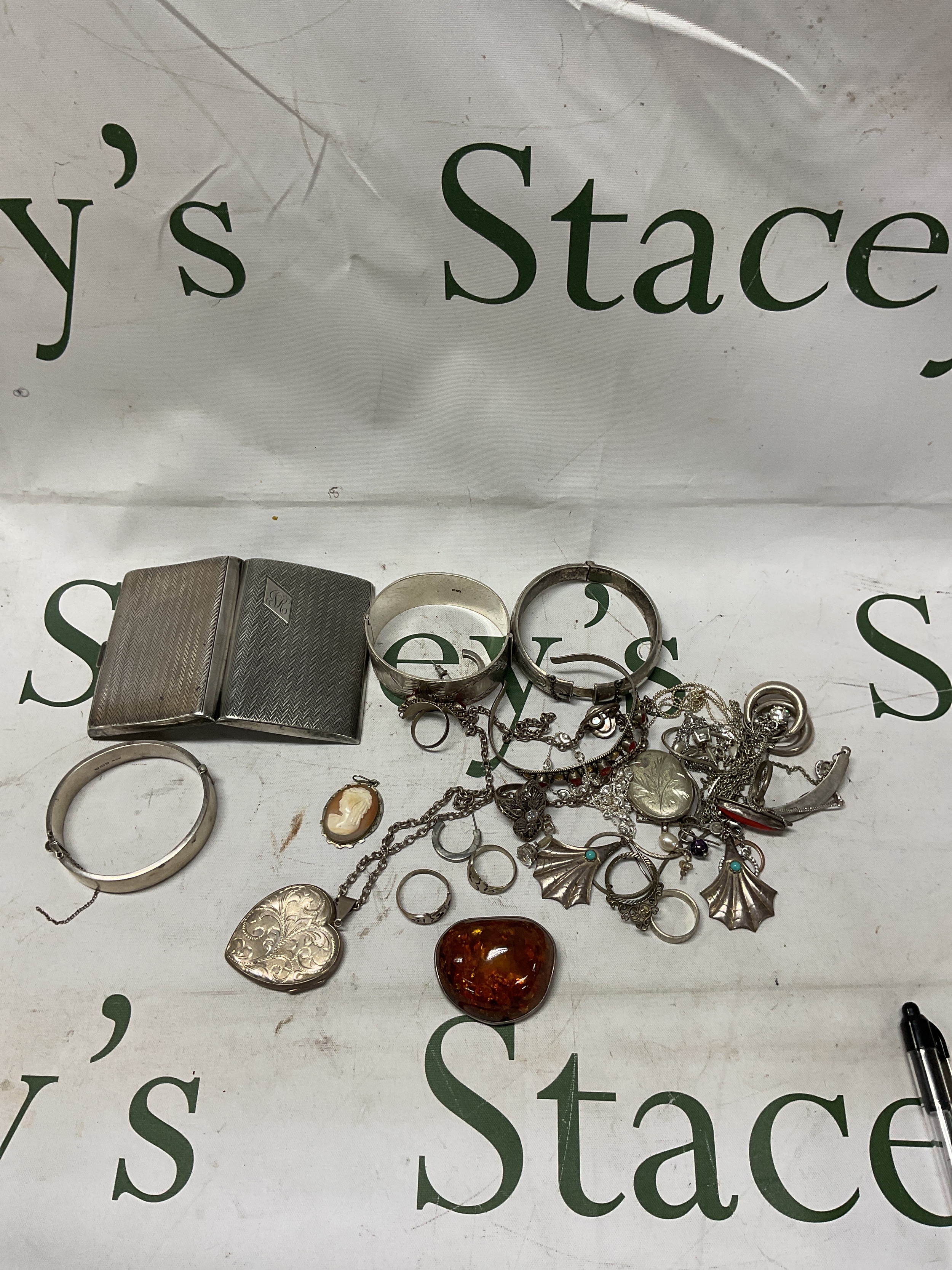 Large qty of silver items to inc cigarette case, jewellery and a large Amber brooch.