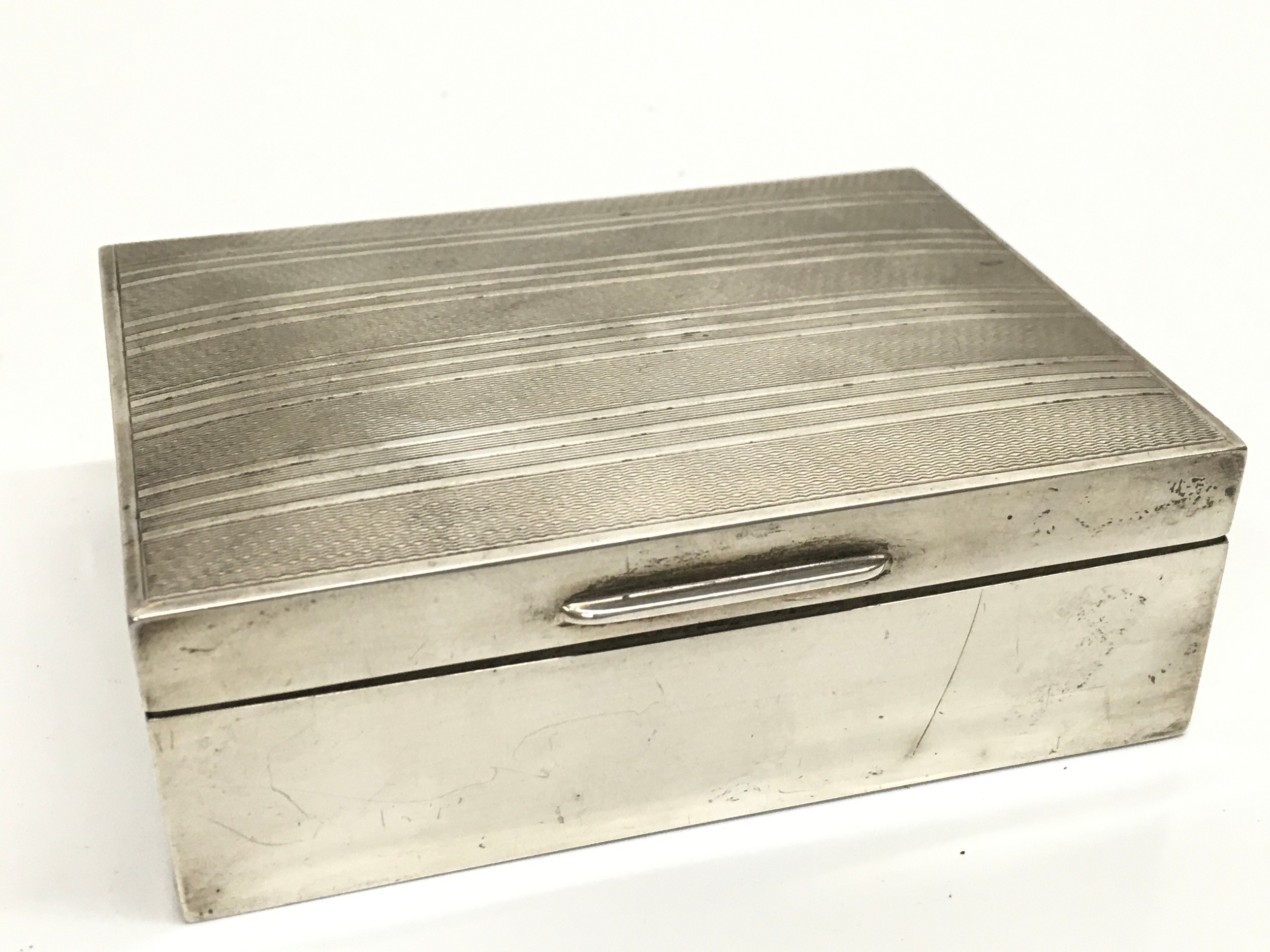 A silver hallmarked cigarette box, marked Birmingham 1962. Dimensions12cm wide 9cm long 4cm tall. 270g total weight