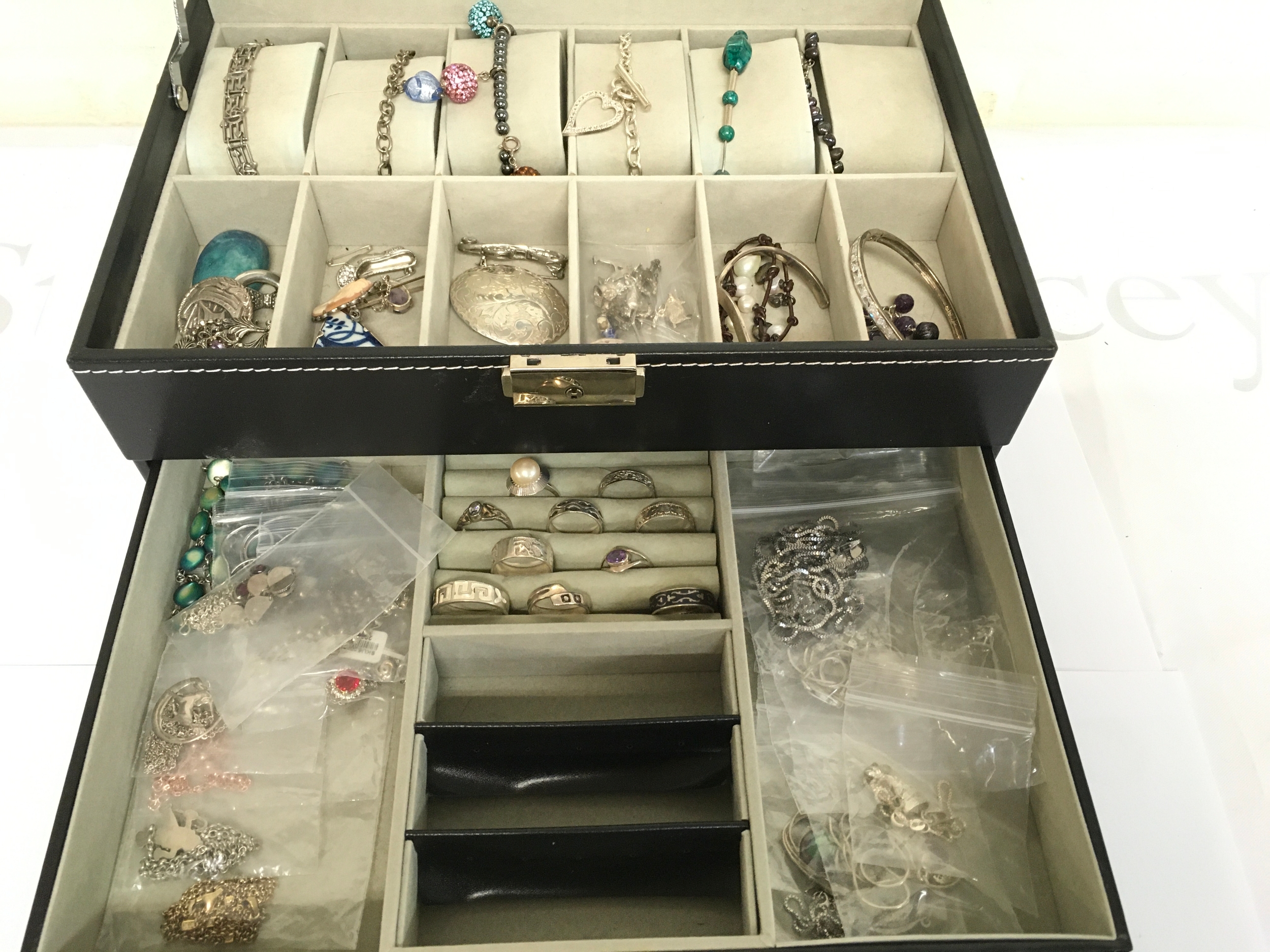 A collection of jewellery including silver necklaces, rings, charms etc