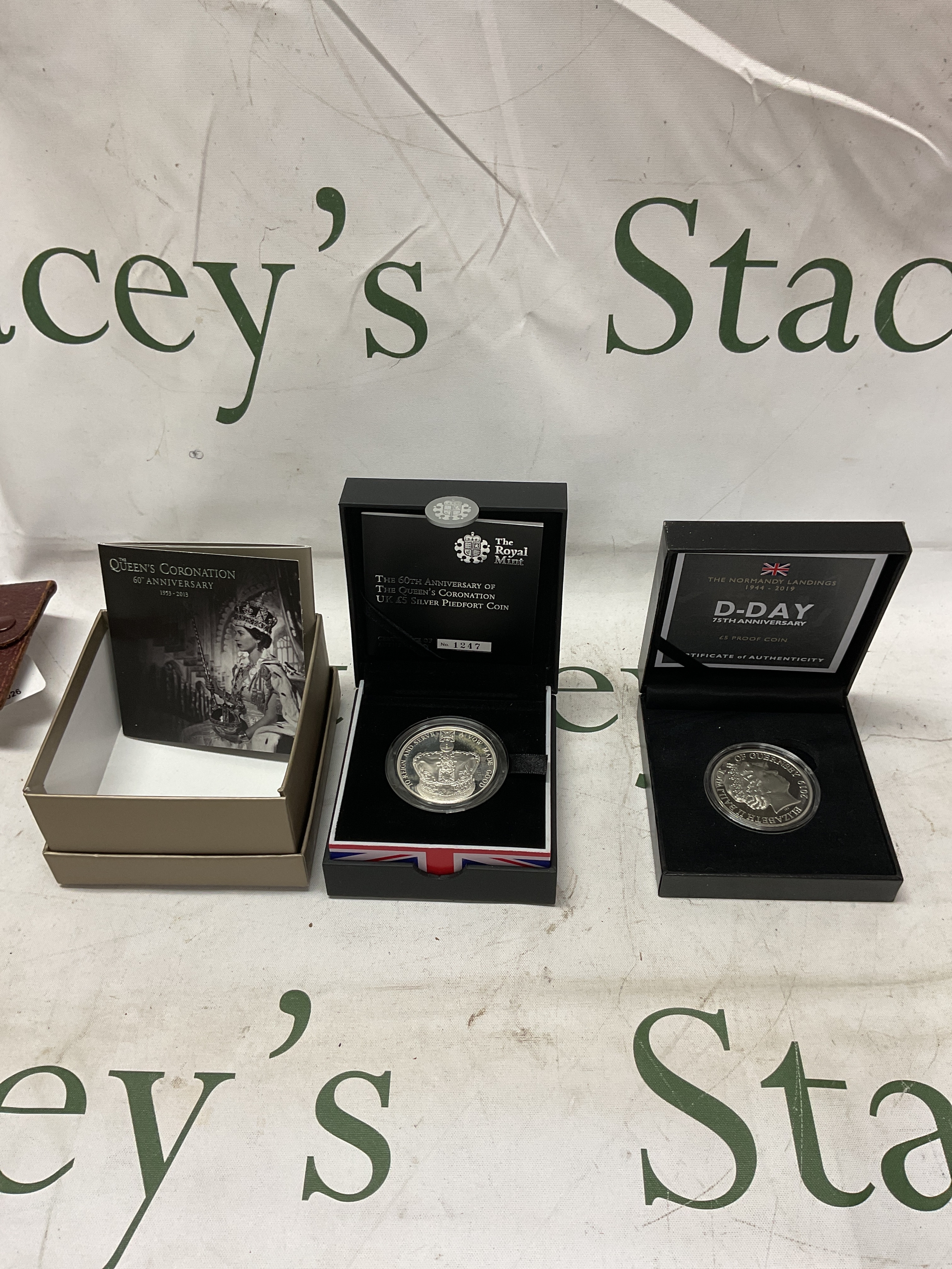 Two cased silver proof boxed coins, D-Day, and 60th Anniversary Piedfort.