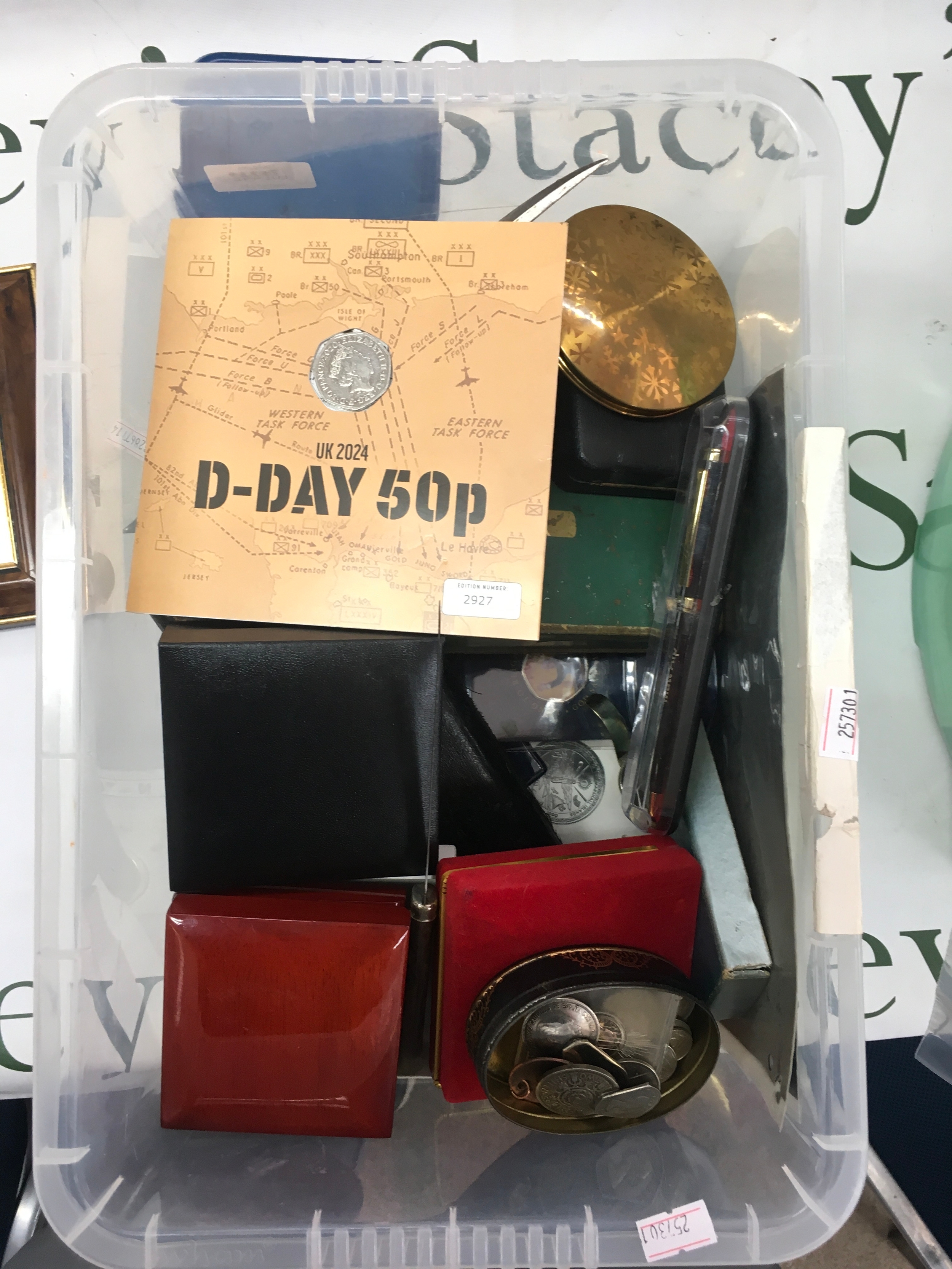 A collection of small collectibles including D-day coins, letter openers and brass items. No obvious damage or reconditioning