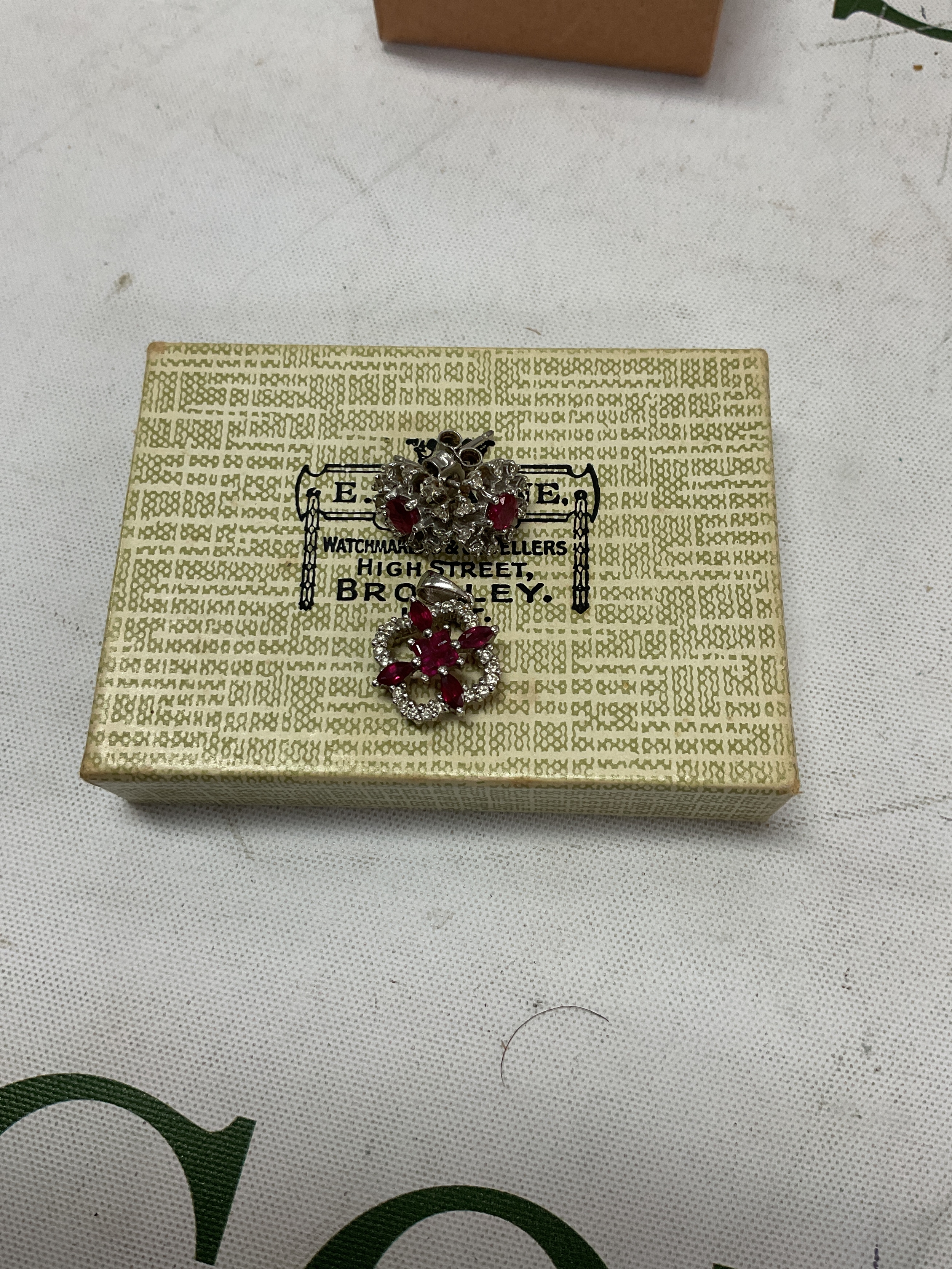 18k ruby pendant and 9ct white gold earrings.