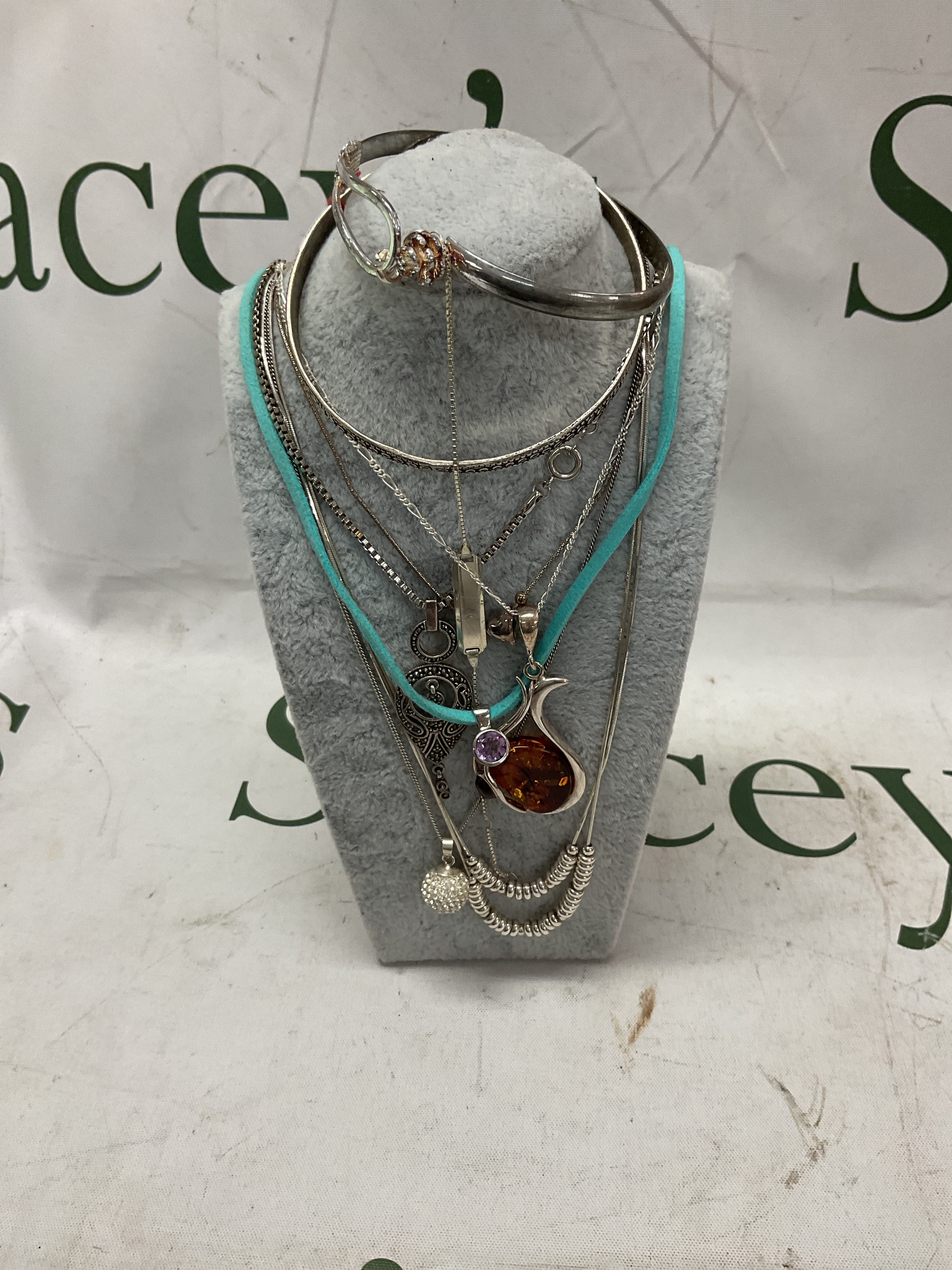 Silver dress necklaces and pendants and bracelets.